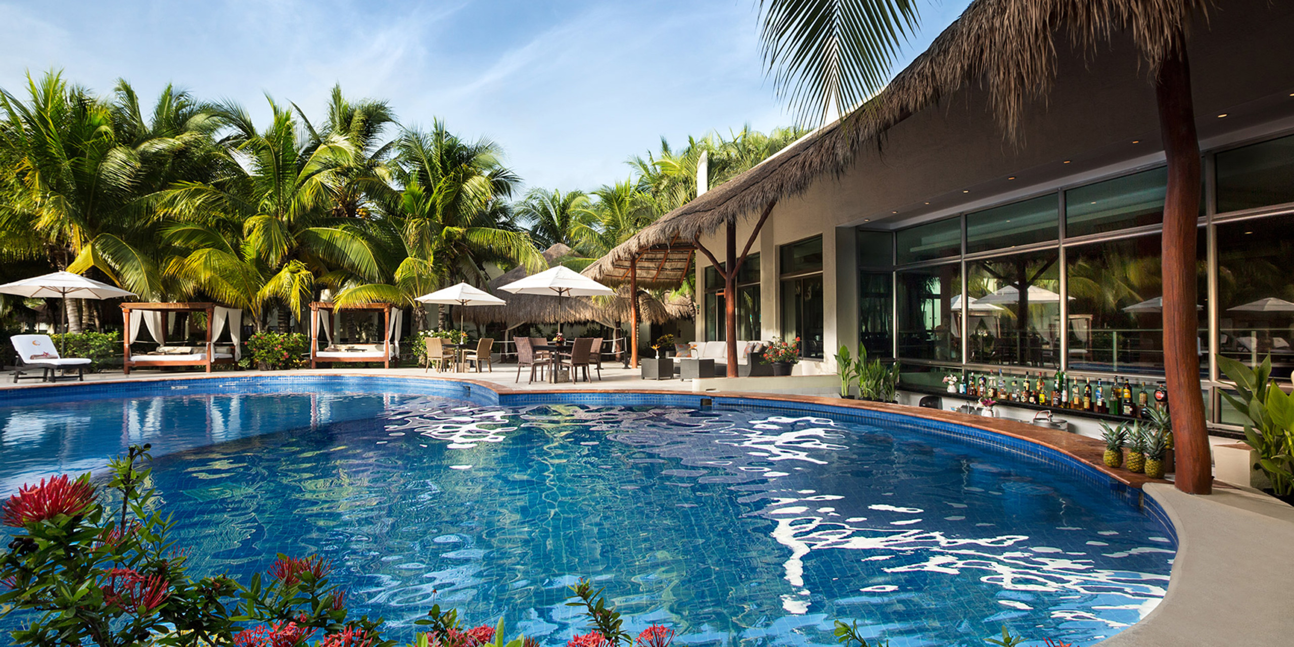 El Dorado Maroma all inclusive destination wedding resort with a luxury pool and lush palm trees