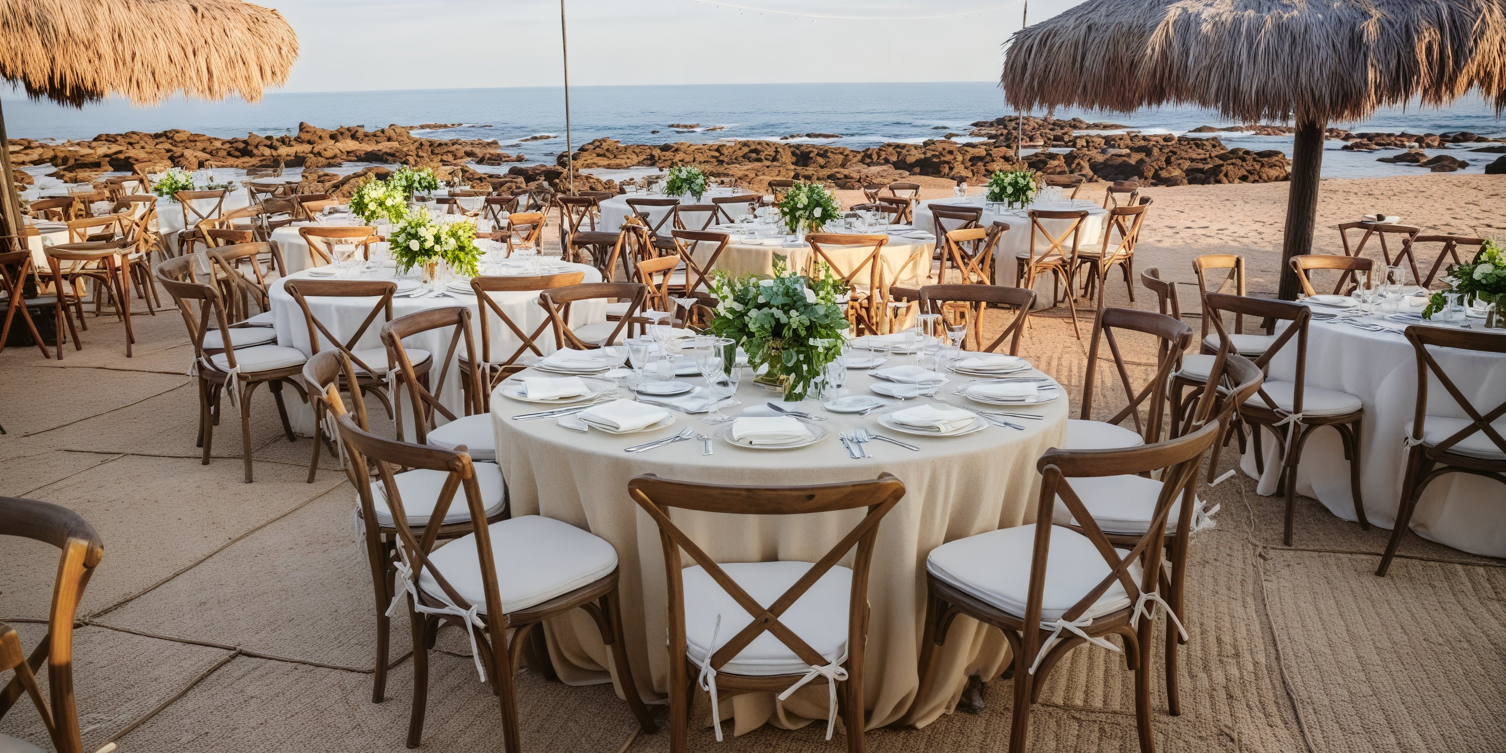 Tables are elegantly arranged for a destination wedding at Grand Fiesta Americana Los Cabos, offering a breathtaking ocean view.