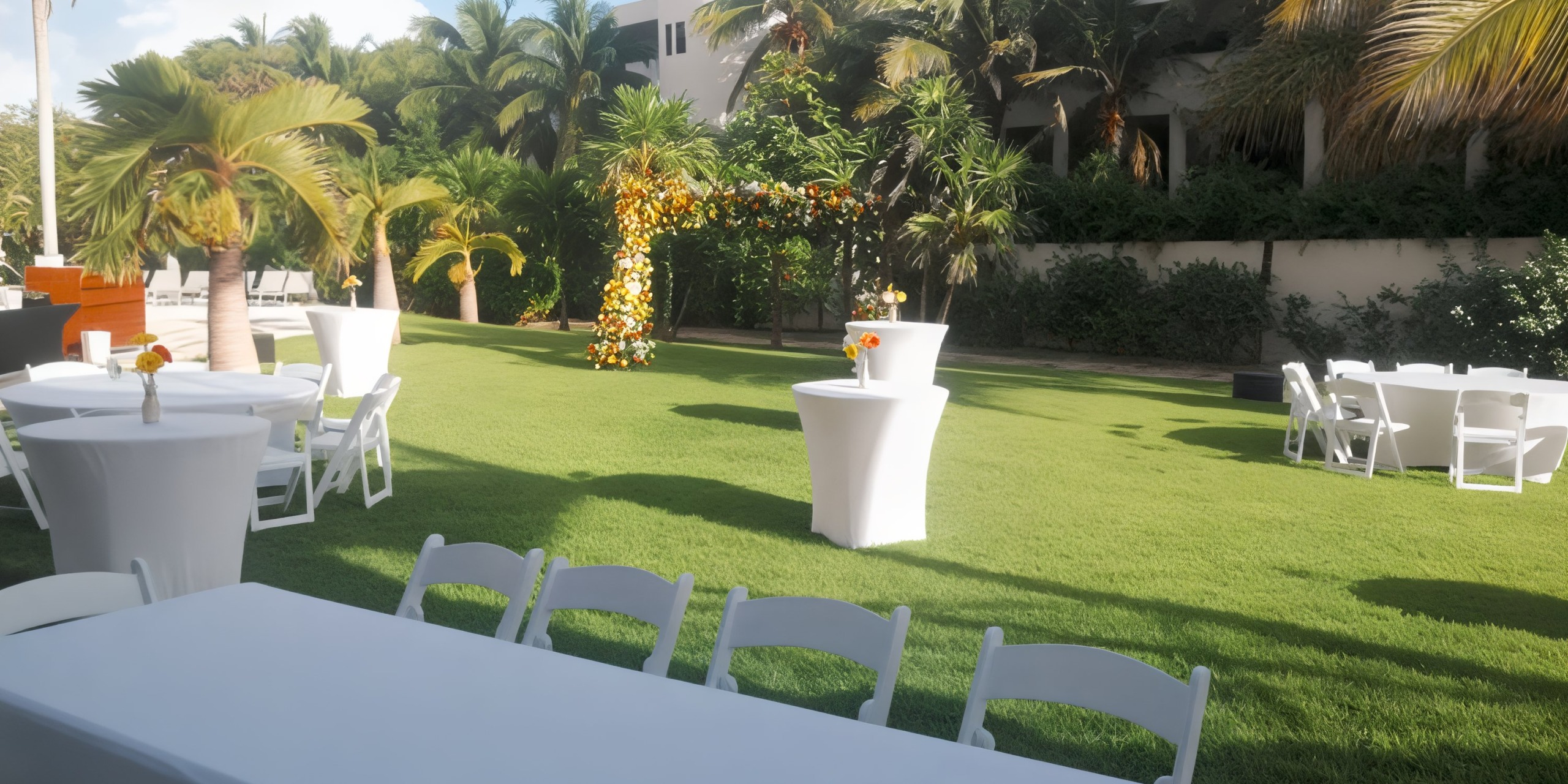 Garden wedding at Hyatt Ziva Riviera Cancun: elegant chairs, beautifully arranged tables, and a stunning floral archway. Perfect for your destination wedding.