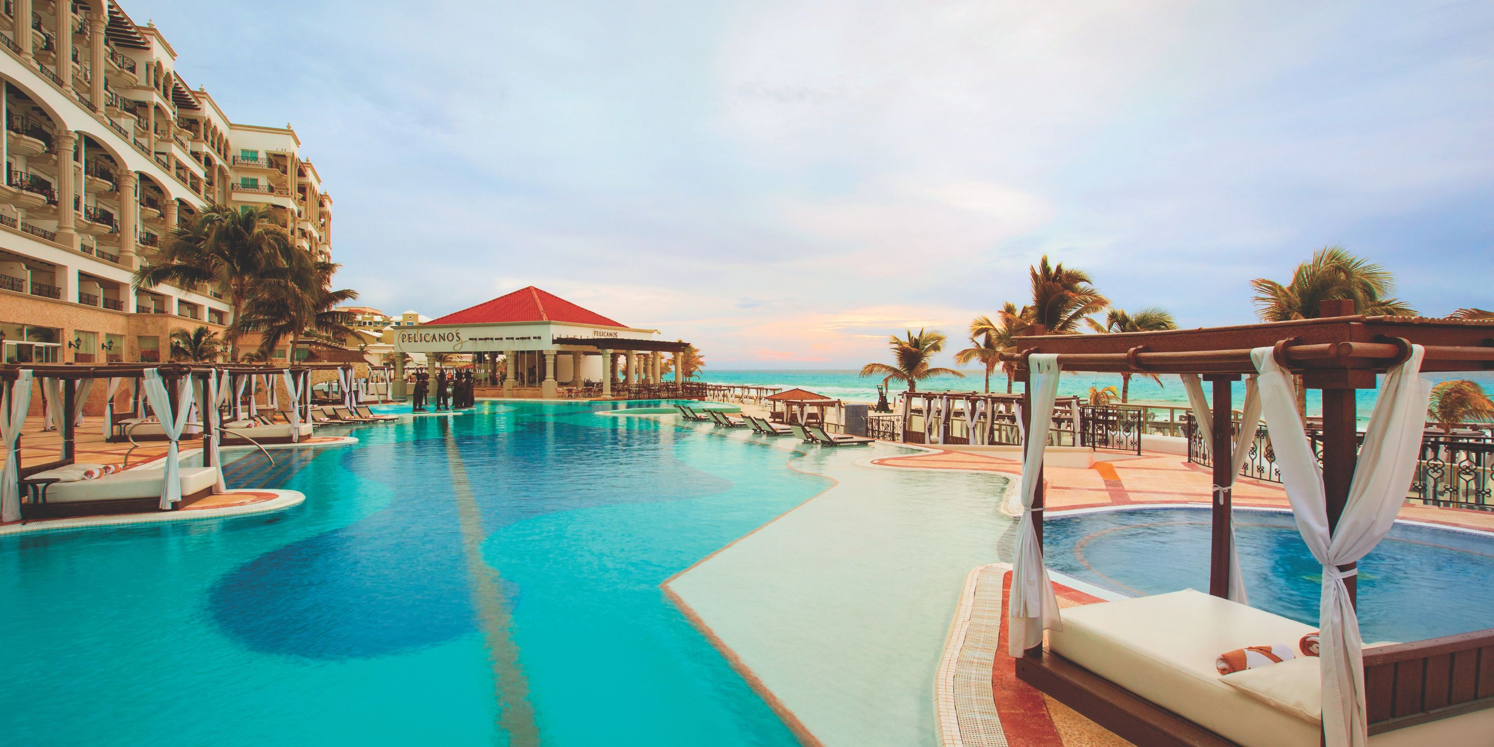 Hyatt Zilara Cancun’s outdoor pool, ideal for a destination wedding, with canopied loungers and ocean view.
