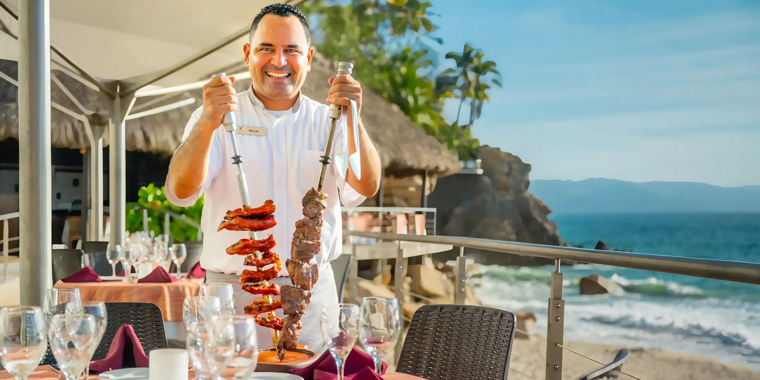 Waiter presenting a skewer of grilled meat at Hyatt Ziva Puerto Vallarta.