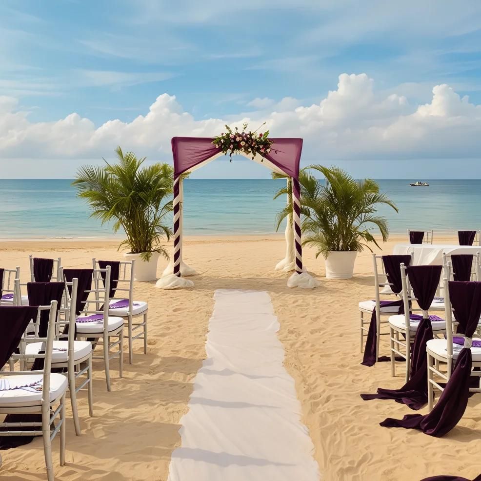 A beach wedding setup with white chairs draped in purple fabric along a central aisle, leading to an arch adorned with flowers and flanked by potted palm trees, set against a serene ocean backdrop.
