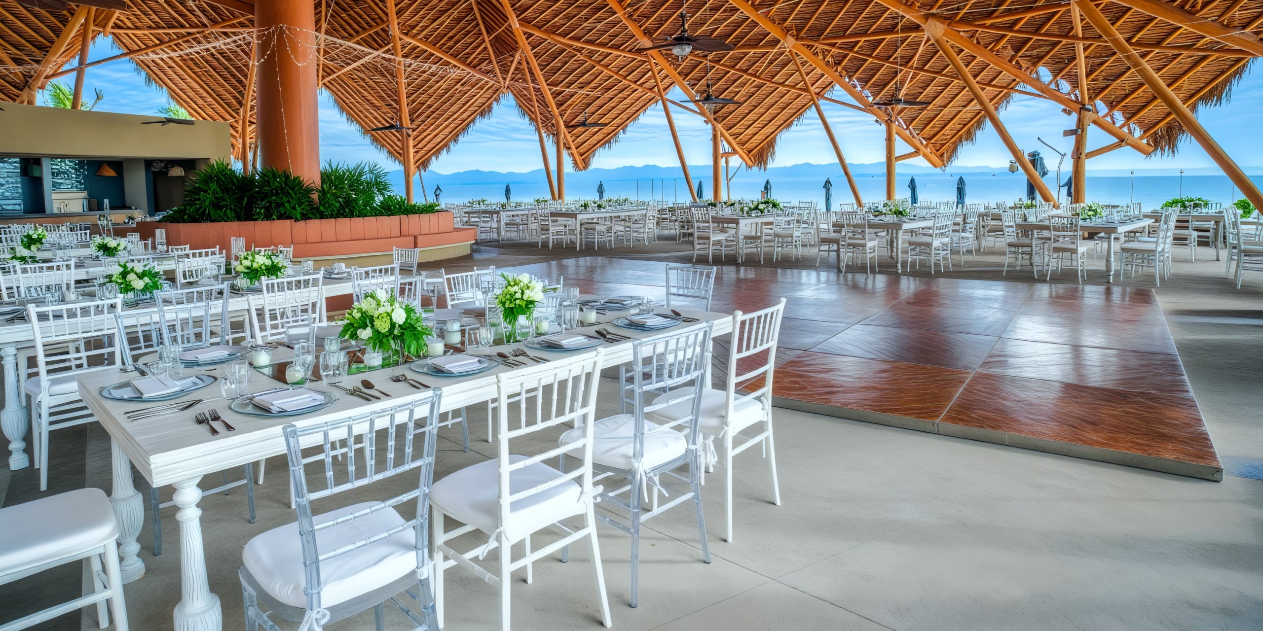 Sophisticated outdoor wedding venue at Marival Armony, featuring white tables, chairs, and exquisite floral decor—ideal for a destination wedding.