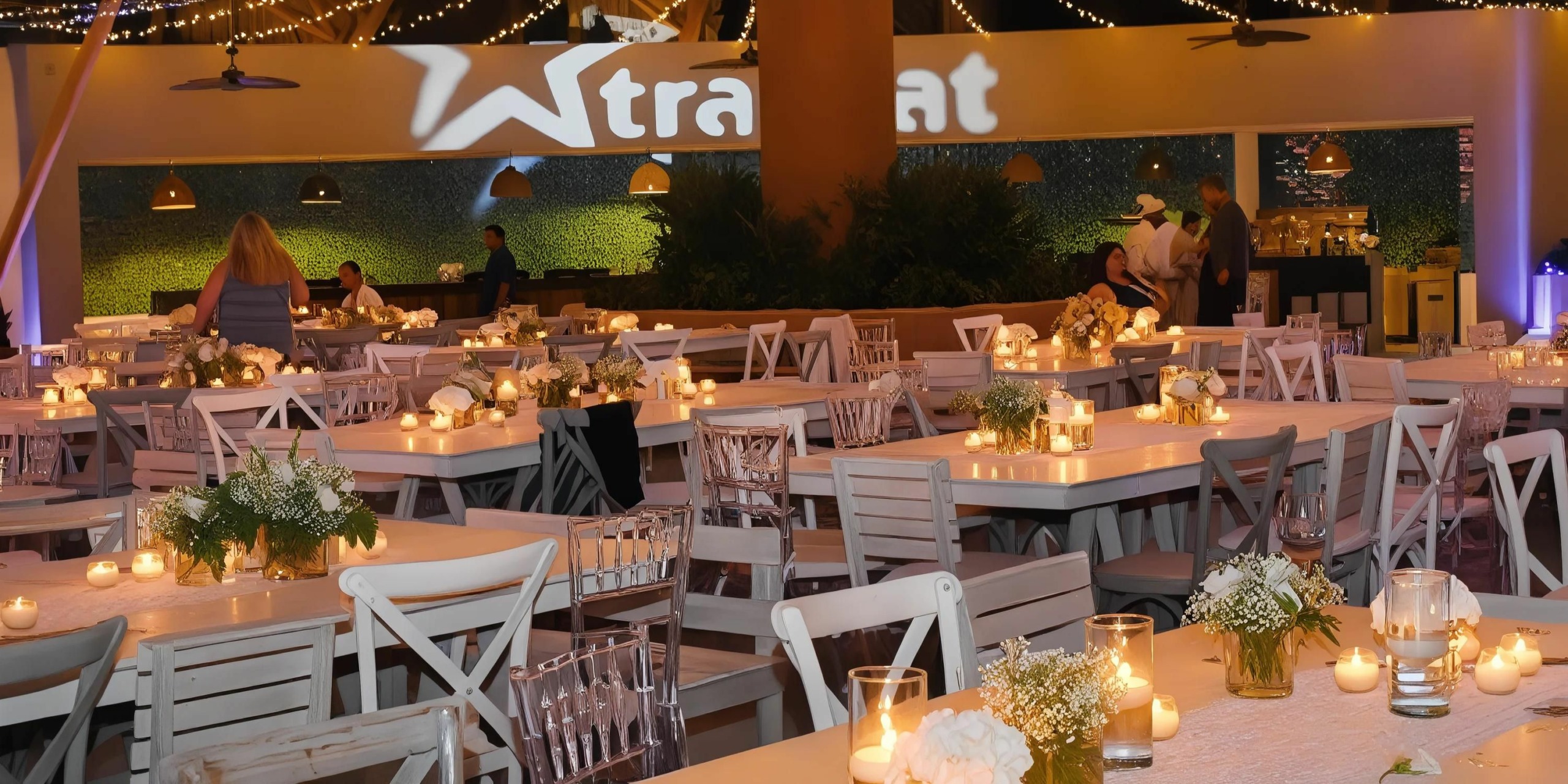 The Marival Armony boasts a spacious indoor dining area, beautifully decorated for an event with tables set with candles and flowers. Warm lighting and lively decor create a festive atmosphere, and a few attendees are seen mingling.