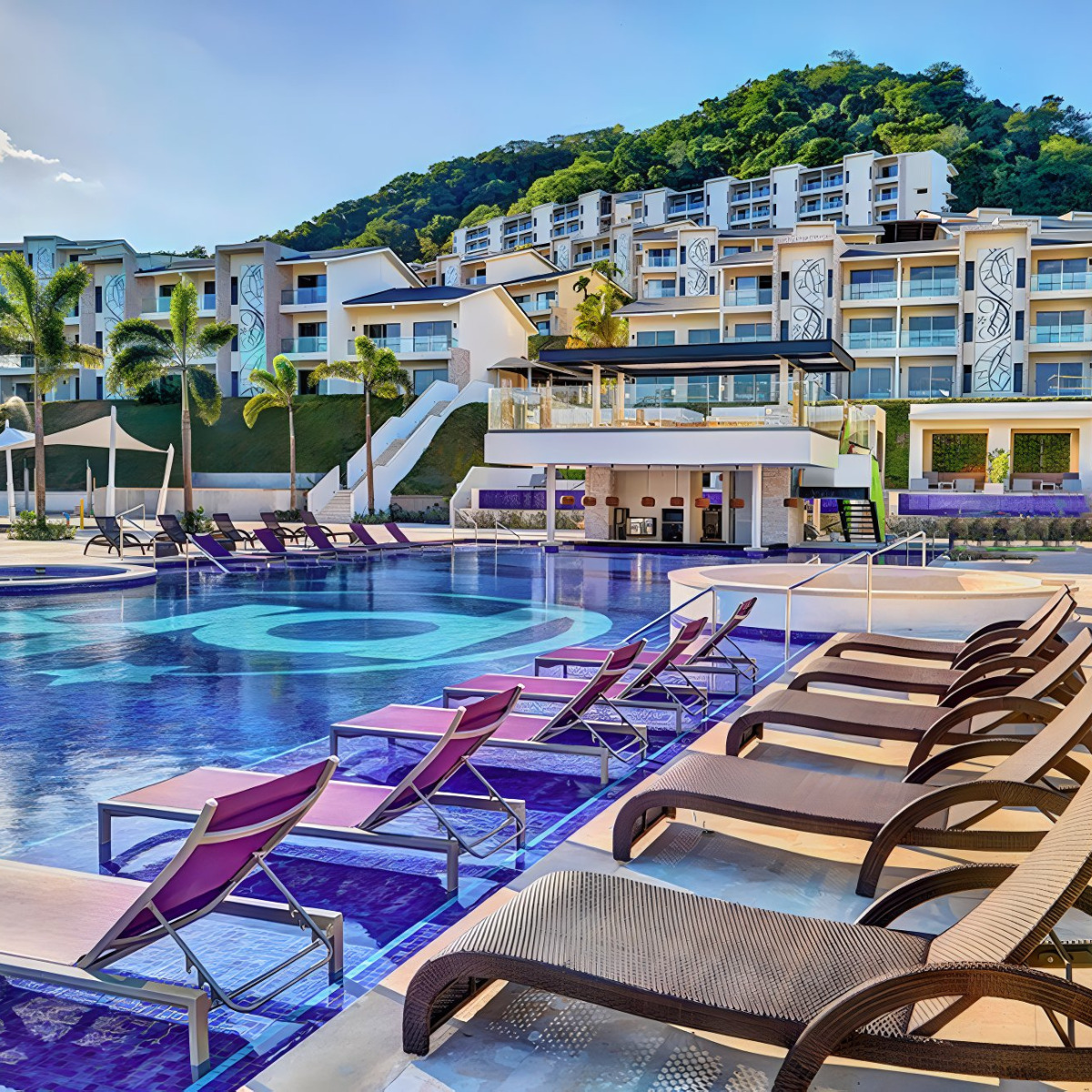 Planet Hollywood Costa Rica perfect for a destination wedding, with large swimming pool, sun loungers, and multi-level buildings in a tropical setting.
