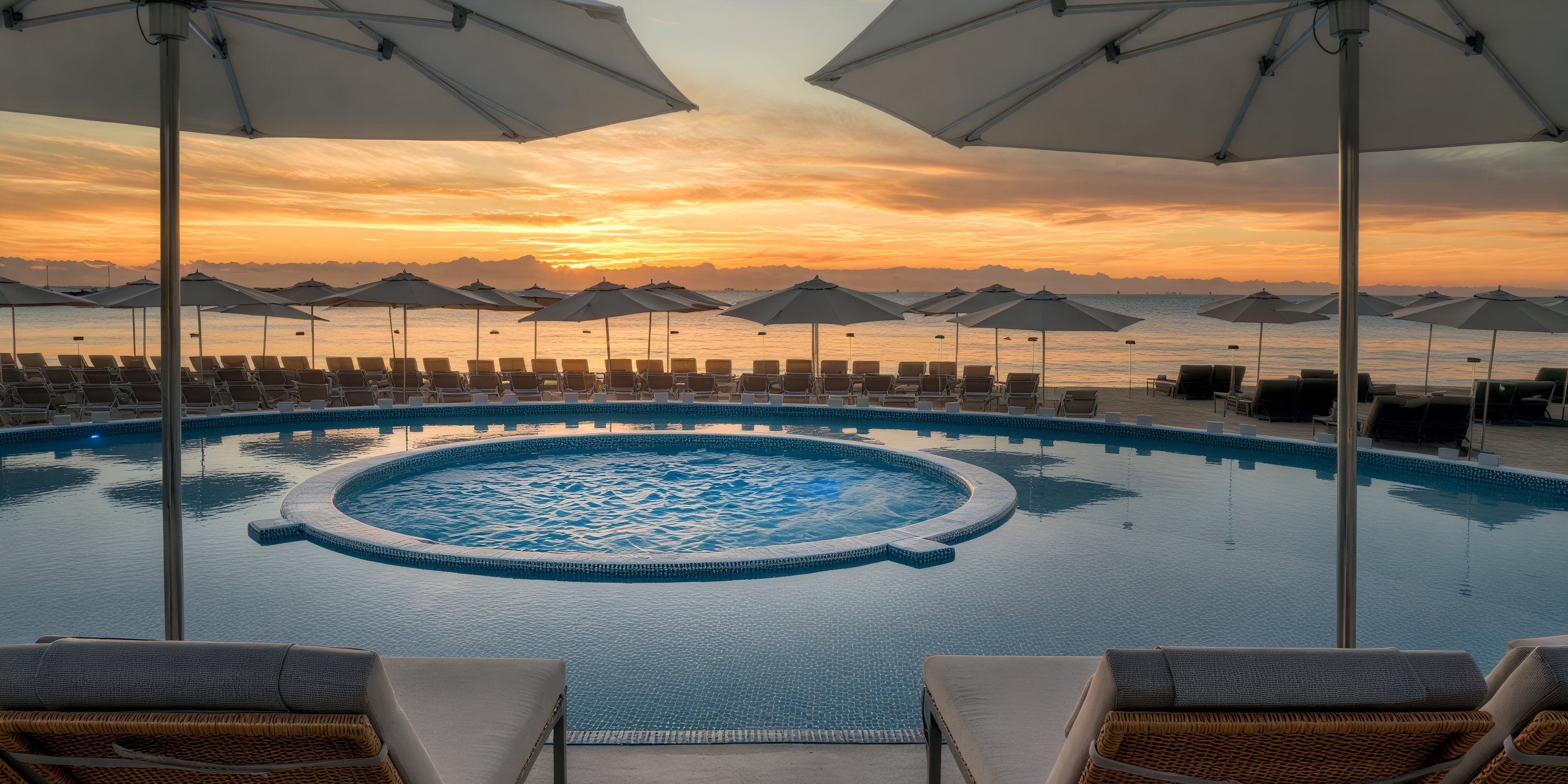 Imagine hosting a destination wedding at Playacar Palace, where the circular pool and umbrellas on the beach create a picturesque backdrop as the sun rises.