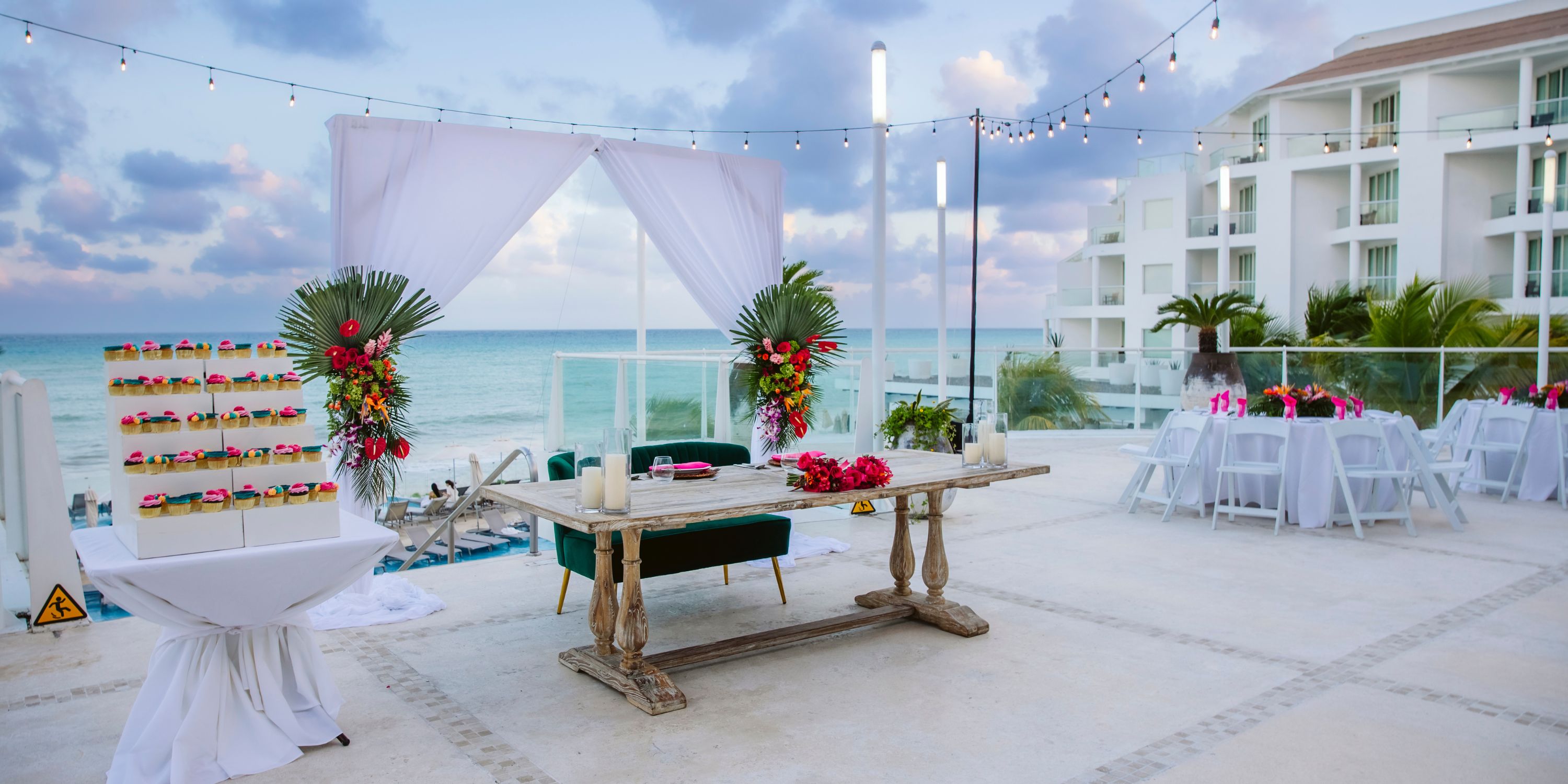 Destination wedding on Playacar Palace terrace, ocean backdrop, beautifully decorated tables and flowers.