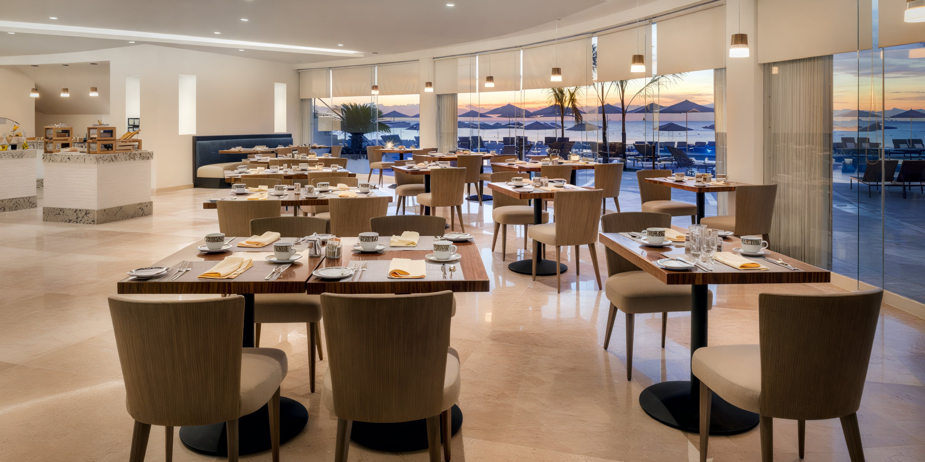 The dining experience at Elegant Playacar Palace is perfect for a destination wedding, with beautifully set tables in a spacious area and stunning ocean views through large windows.
