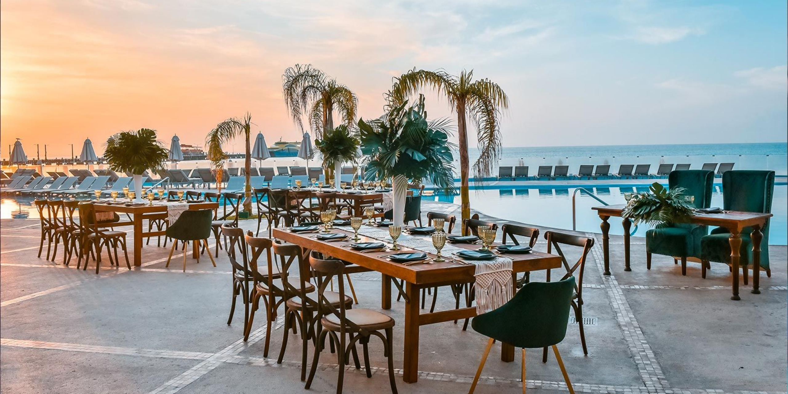 Solarium near the pool with pool chairs and tables set up for a reception after a destination wedding