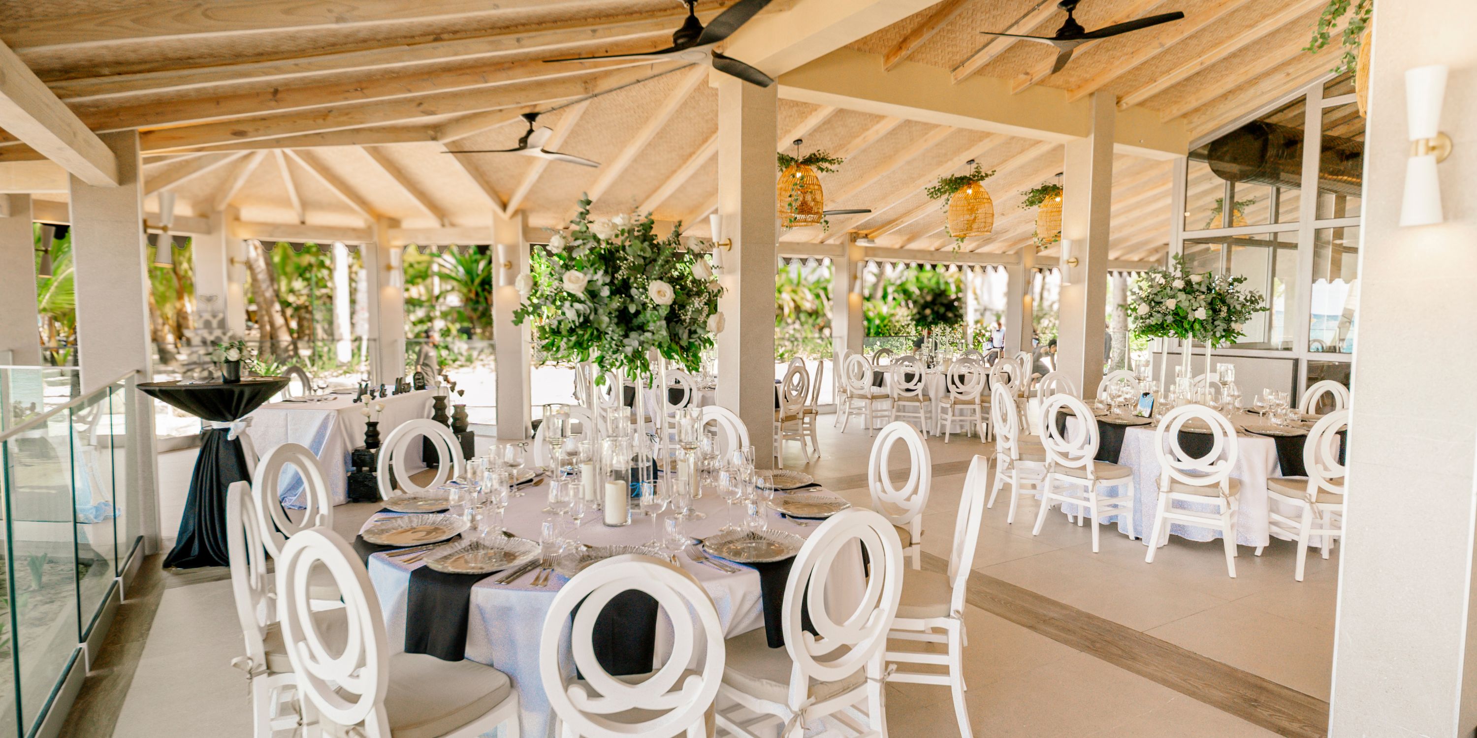 Elegant dining setup at Hotel Riu Palace Macao for a destination wedding, with round tables and floral decor.