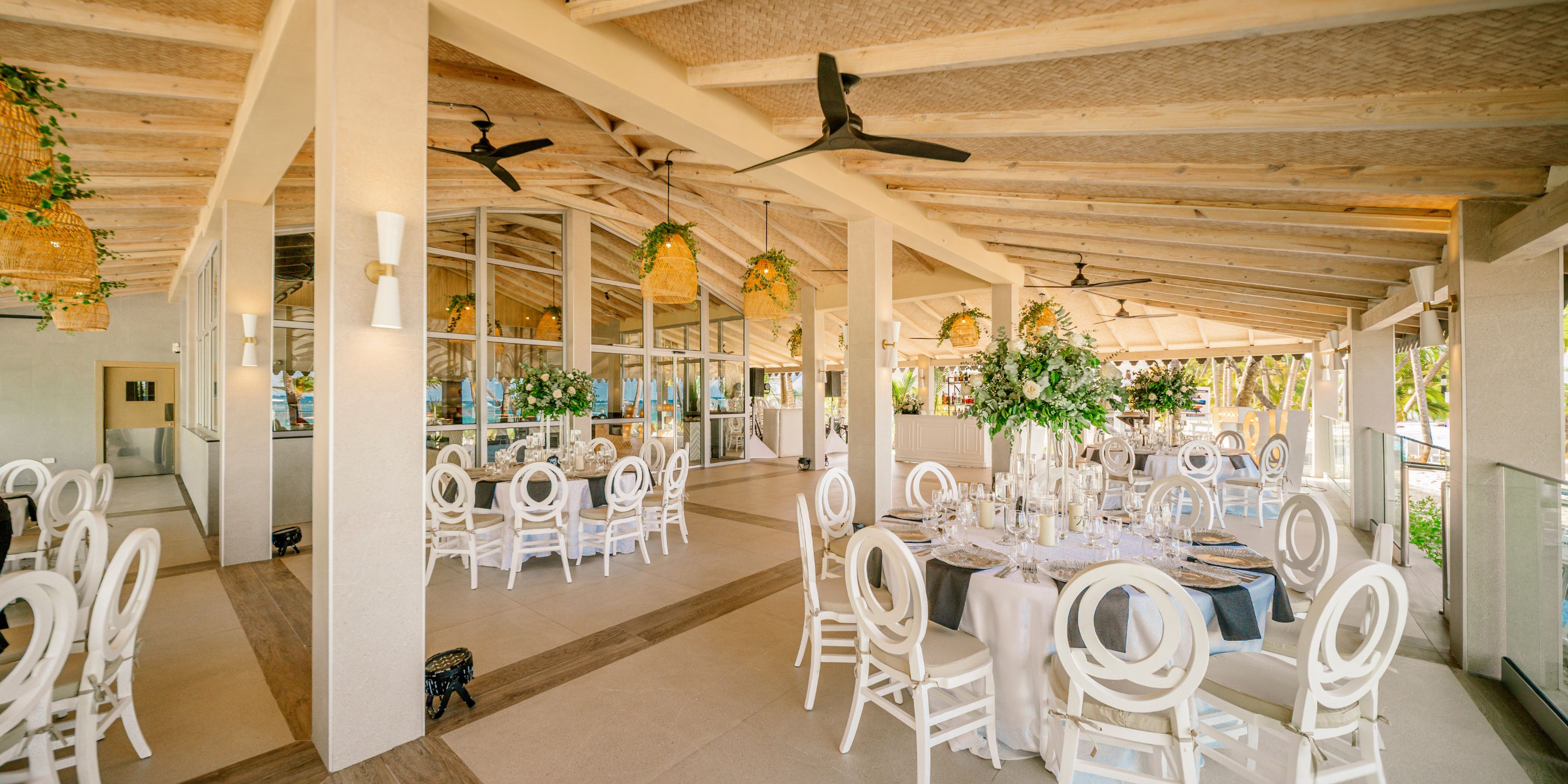 Elegant Hotel Riu Palace Macao set for a destination wedding, with white decor, round tables, and floral centerpieces.