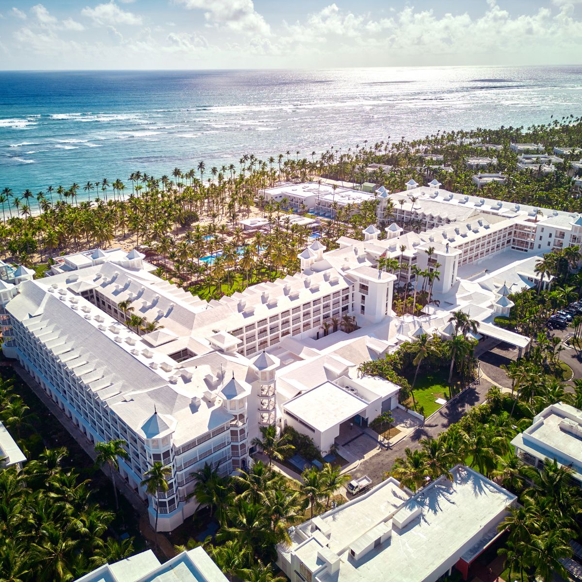 Aerial view of Hotel Riu Palace Macao, ideal for a destination wedding with beachfront, palms, and ocean.