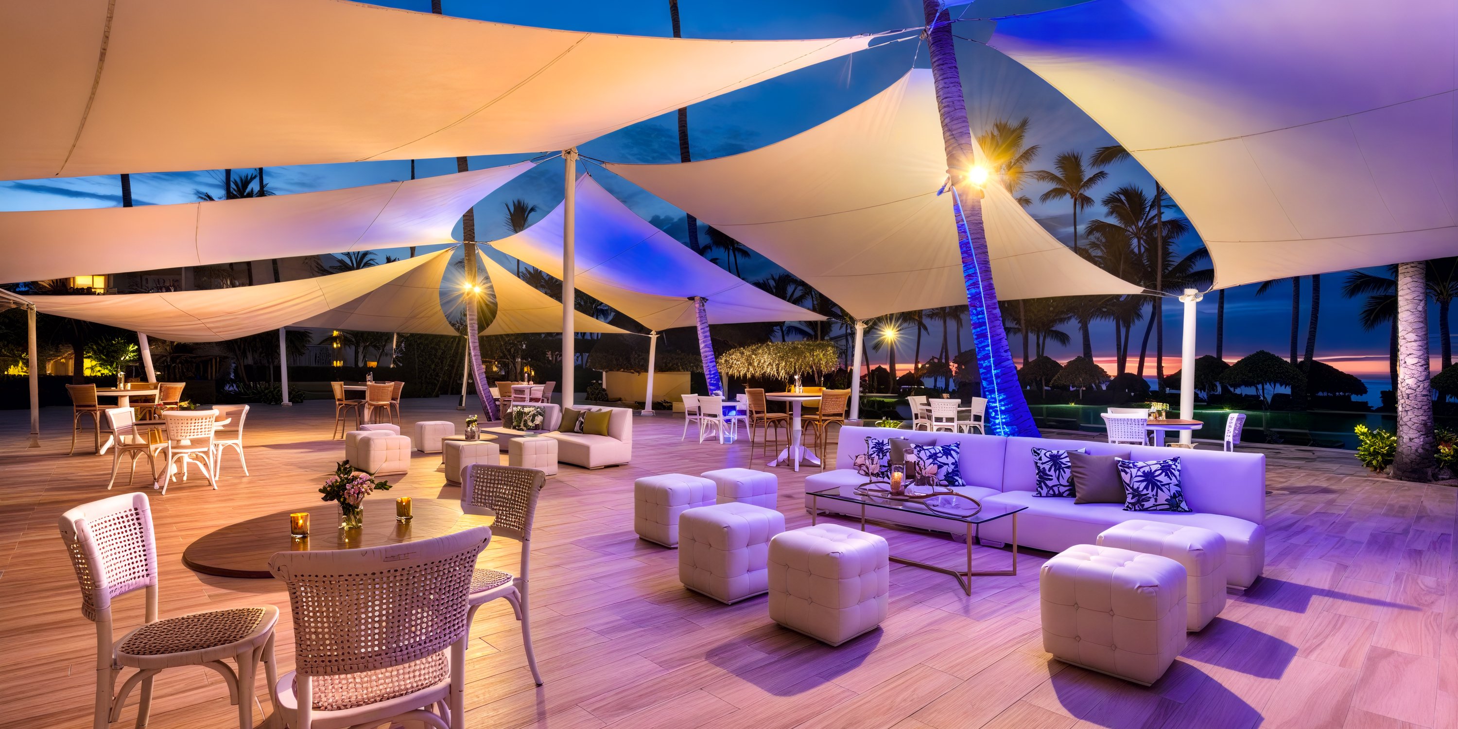 Royalton Punta Cana: A beautiful outdoor lounge featuring elegant white furniture and canopy lighting at dusk, perfect for a picturesque destination wedding.
