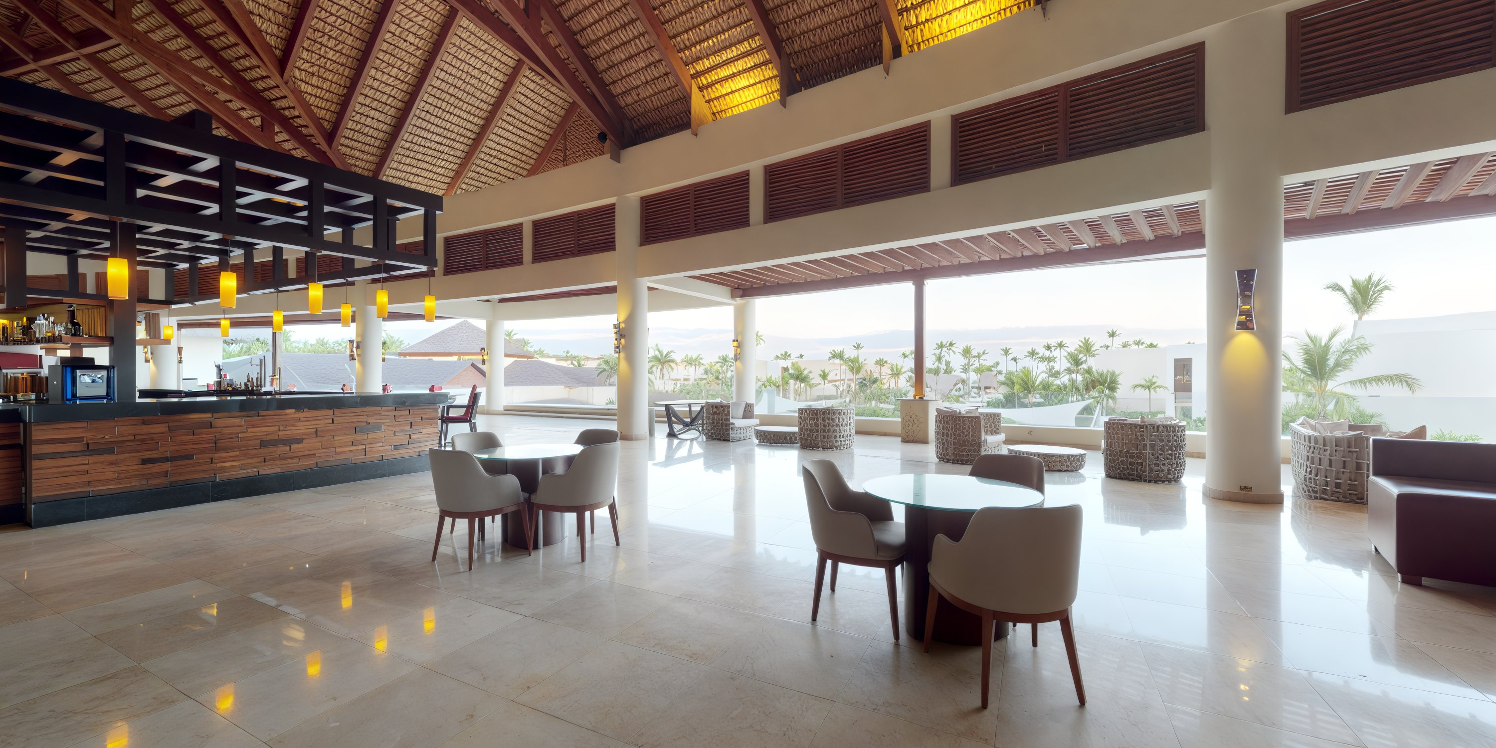 The contemporary lobby at Royalton Punta Cana boasts expansive windows that offer a stunning tropical backdrop, perfect for those planning a destination wedding.