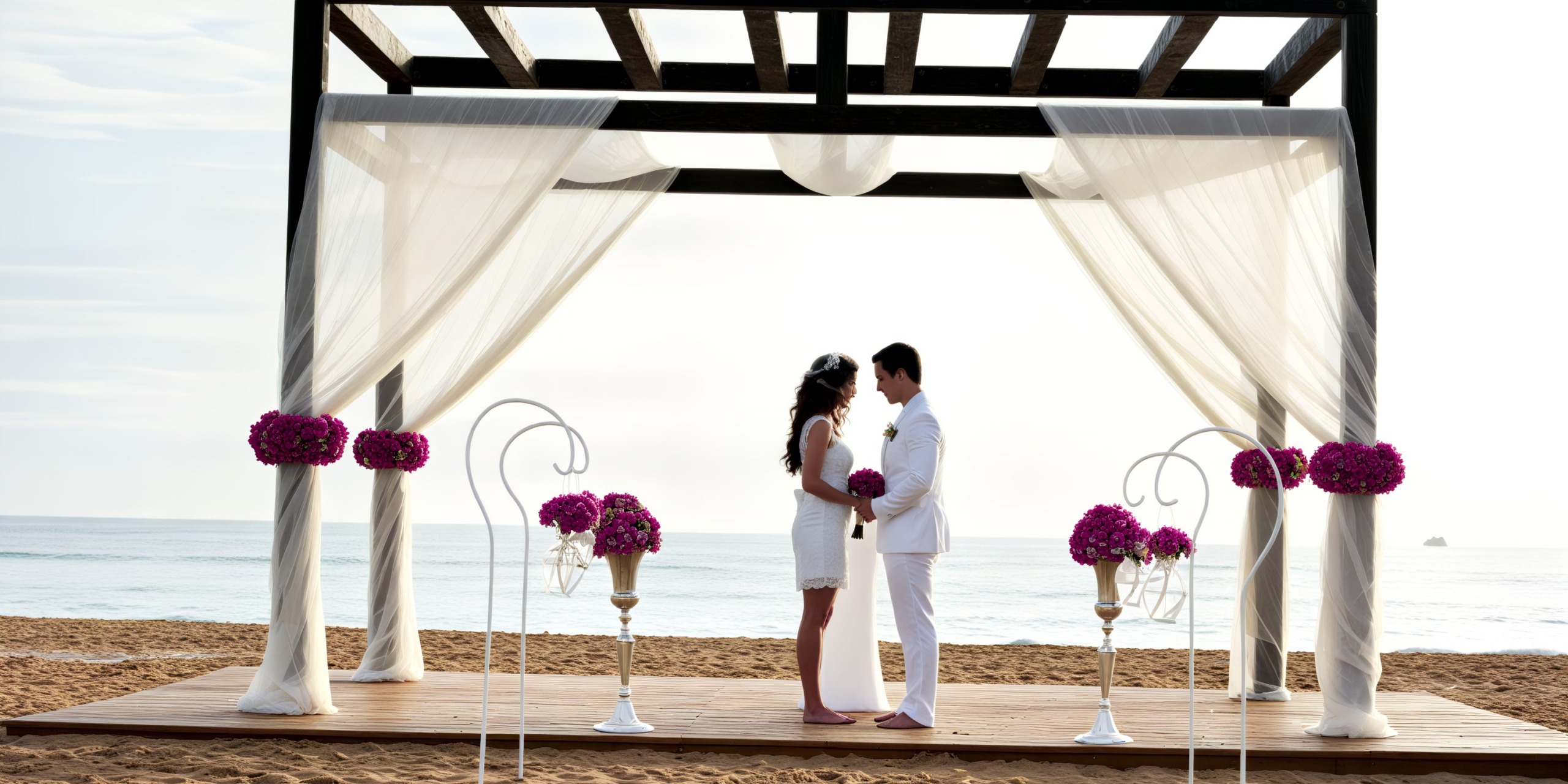 A couple stands beneath a beach gazebo during their destination wedding ceremony.