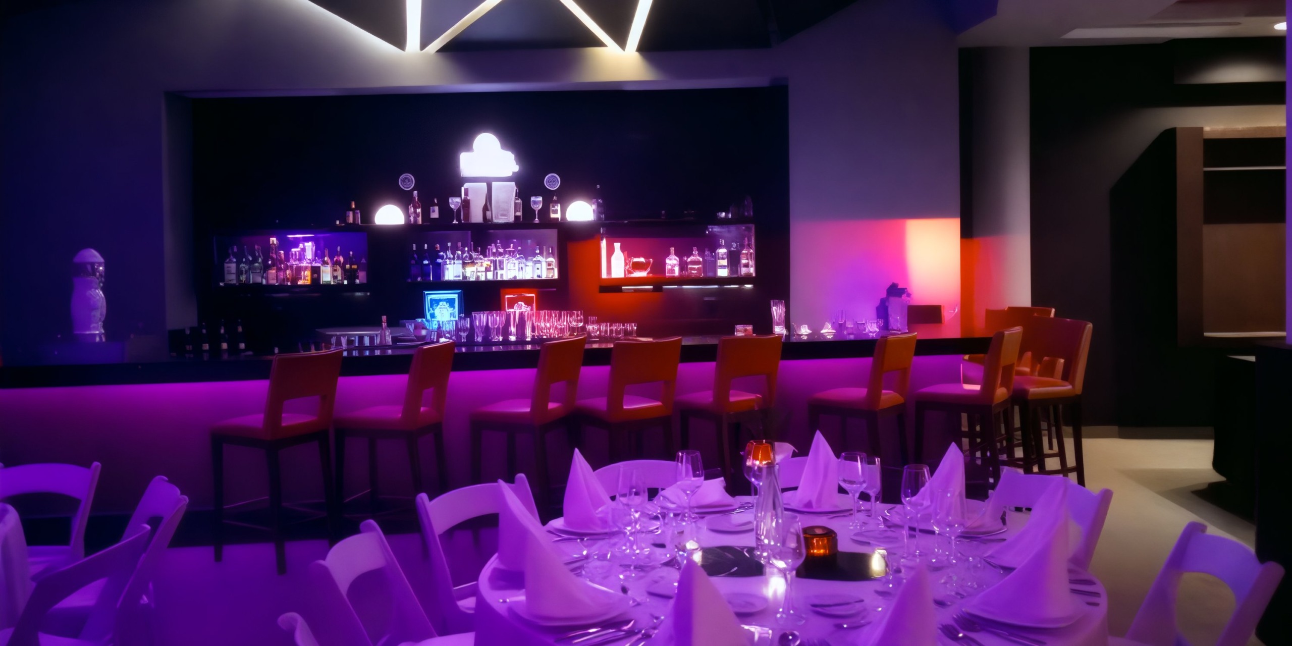 Discover a chic bar perfect for a destination wedding at Royalton CHIC Punta Cana. With its dim lighting, elegant purple tones, and stylish white chairs, this venue creates an unforgettable atmosphere.