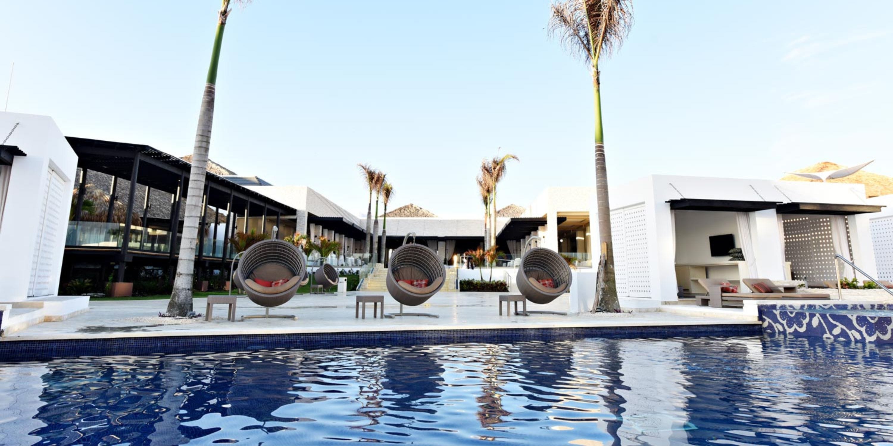 Modern poolside at Royalton CHIC Punta Cana—ideal for a destination wedding with chic loungers.