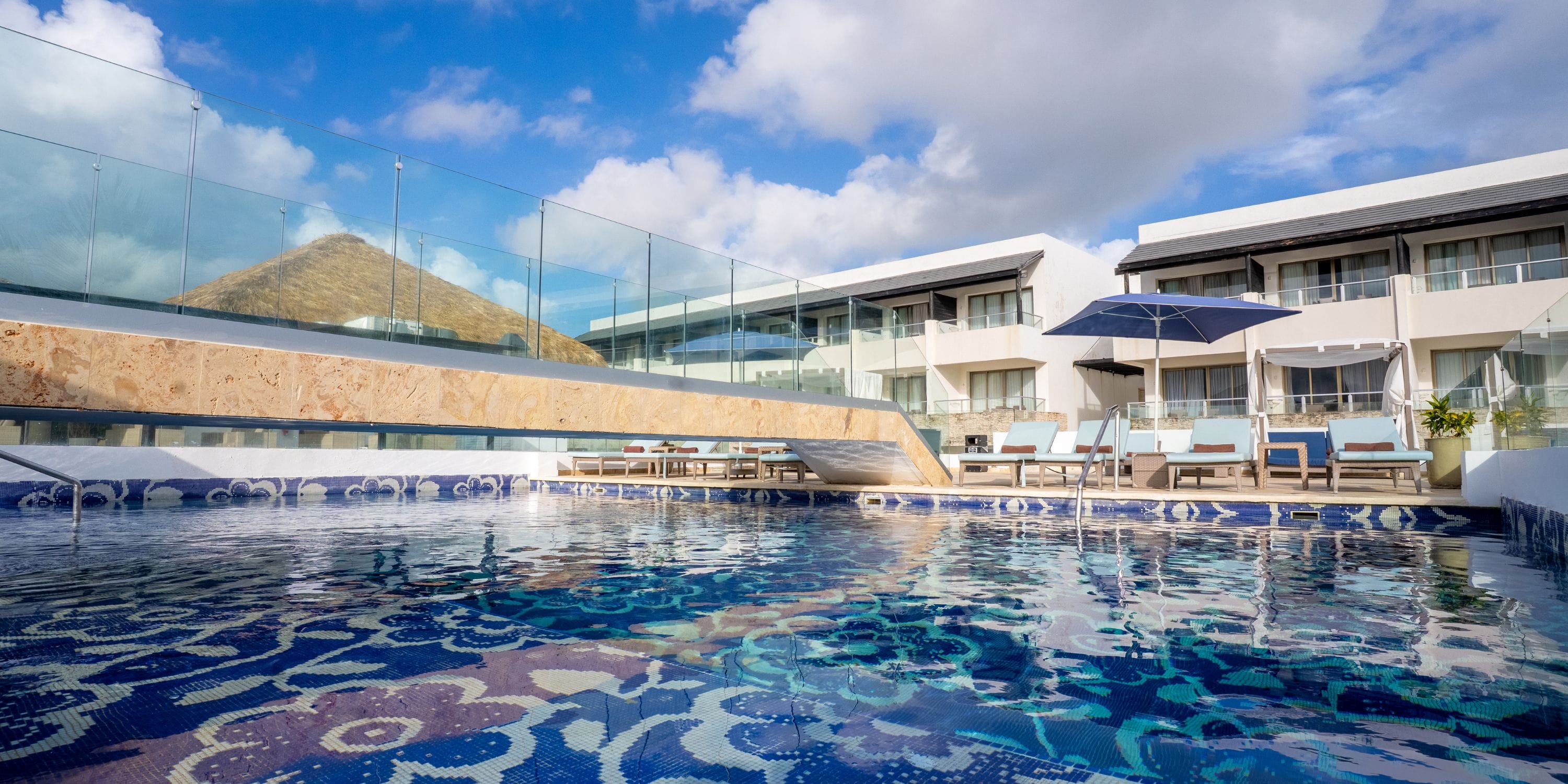 Outdoor pool at Royalton CHIC Punta Cana, an elegant destination wedding spot with lounge chairs.