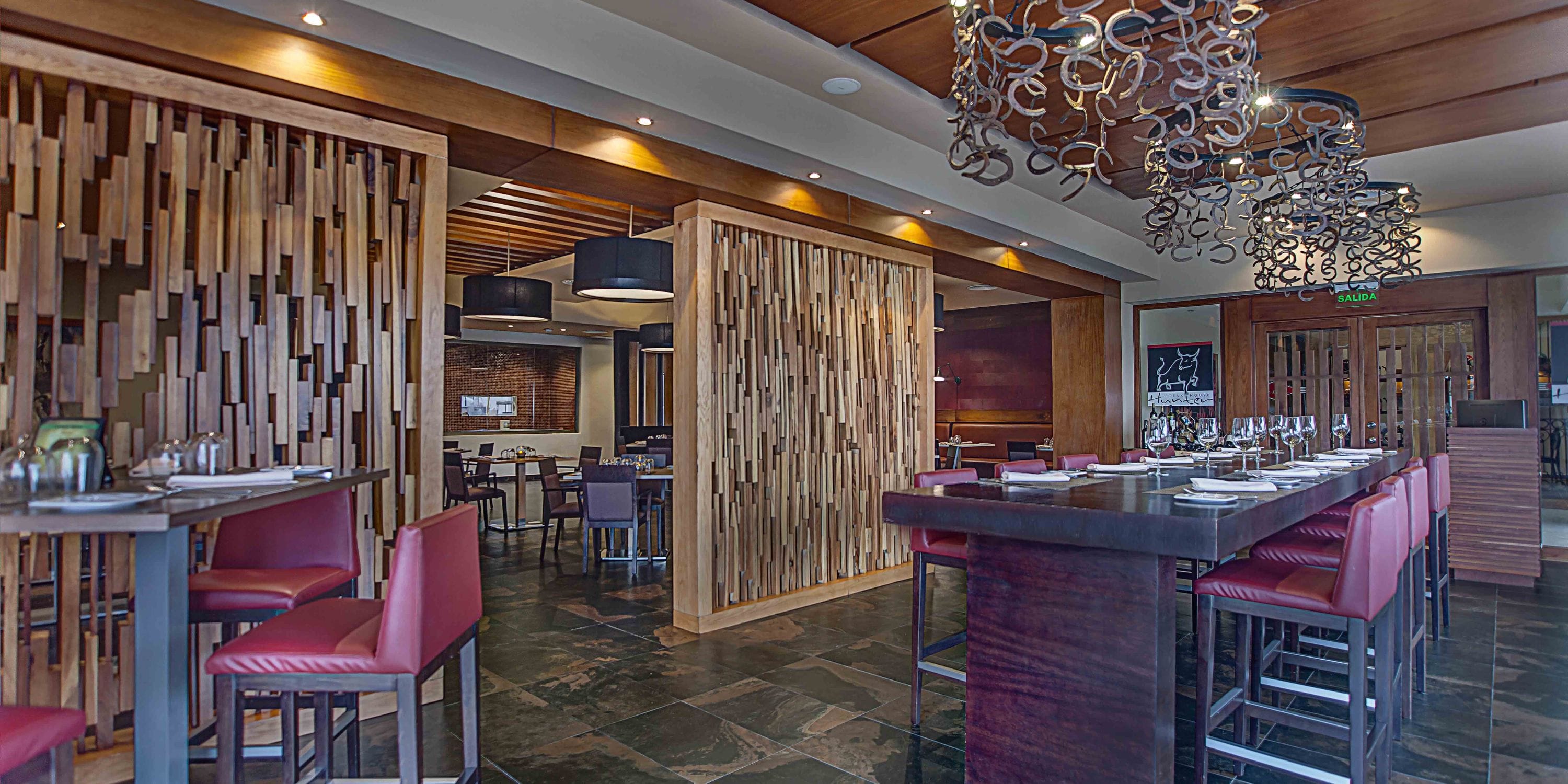 Modern interior at Royalton CHIC Punta Cana, ideal for a destination wedding, with red chairs.