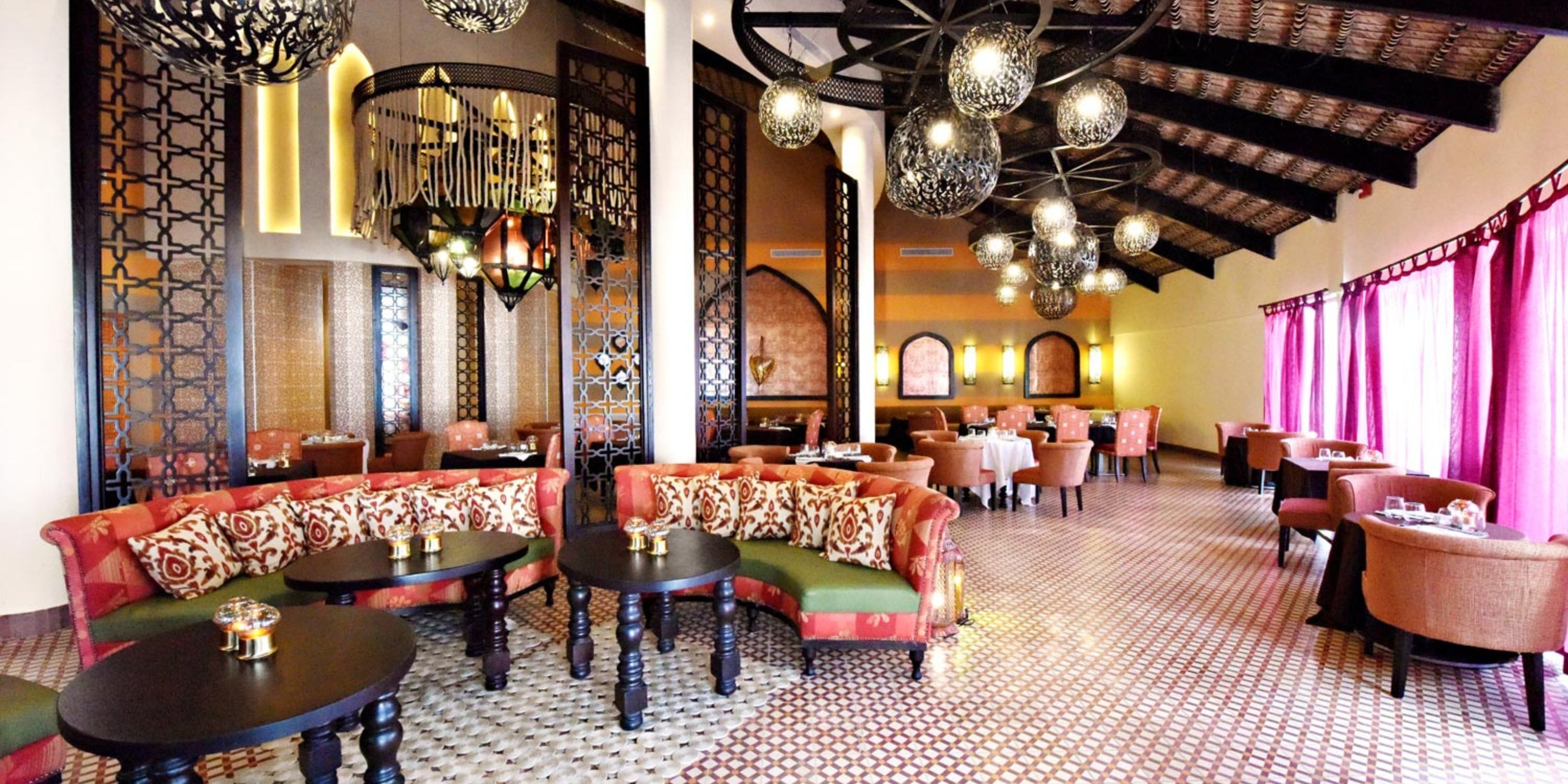 Royalton CHIC Punta Cana: An elegant destination wedding venue with plush seats & ornate decor.