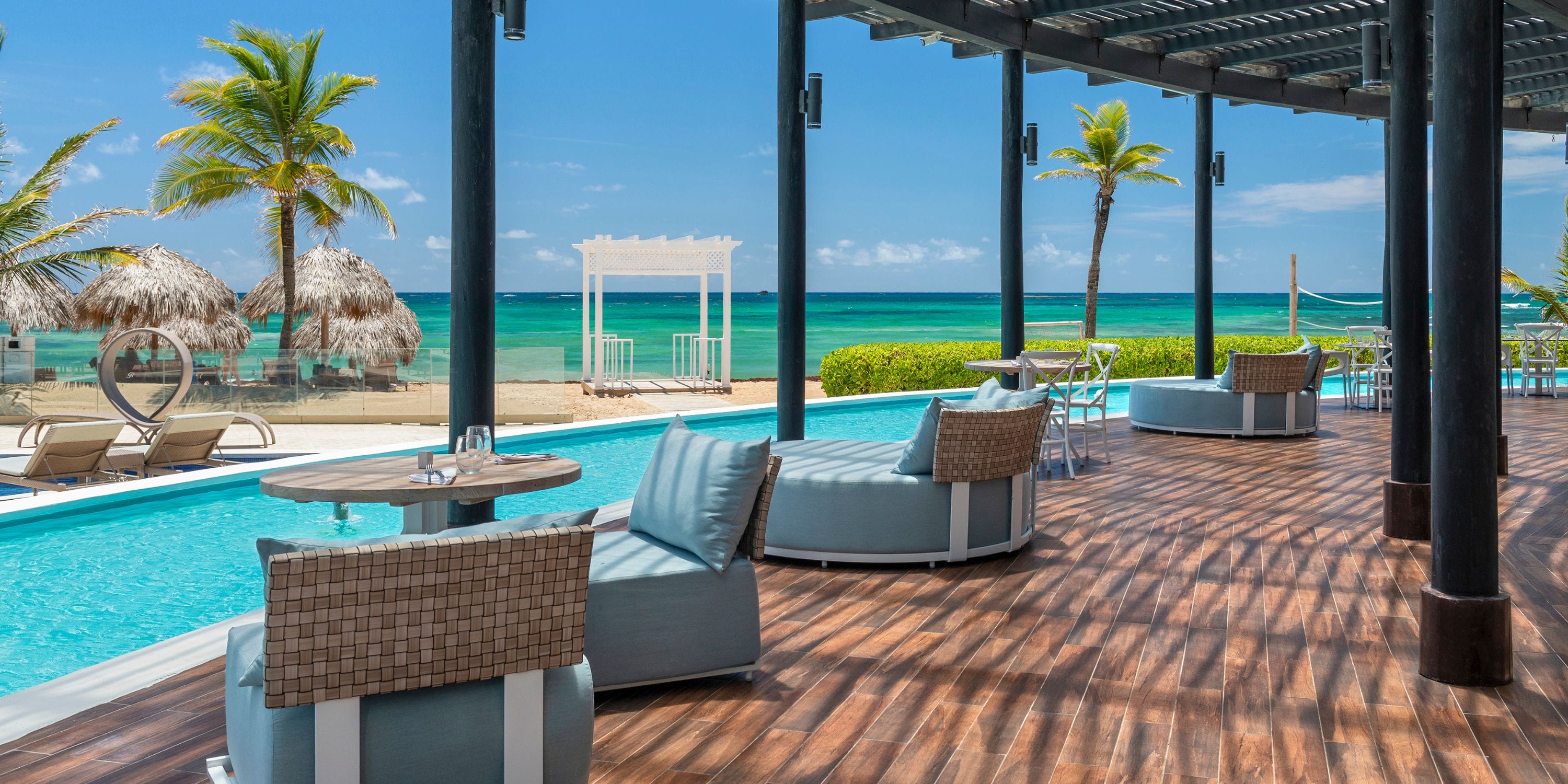 Poolside lounge at Royalton CHIC Punta Cana, perfect for a destination wedding, with beach views.