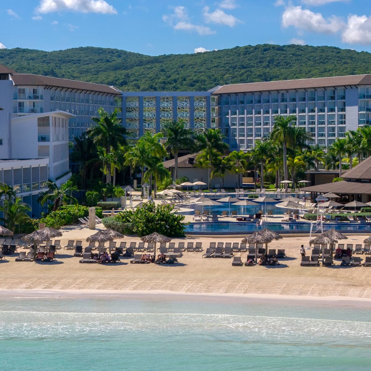 Royalton Hideaway Blue Waters: popular destination wedding resort with palm trees, pool, and modern buildings.