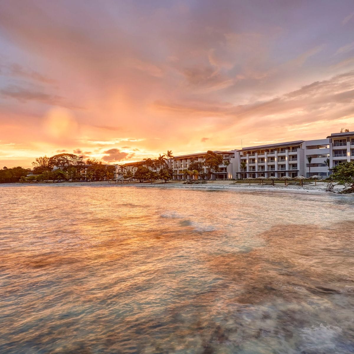 Royalton Hideaway Negril resort at sunset, perfect for a destination wedding with calm water and vivid sky.