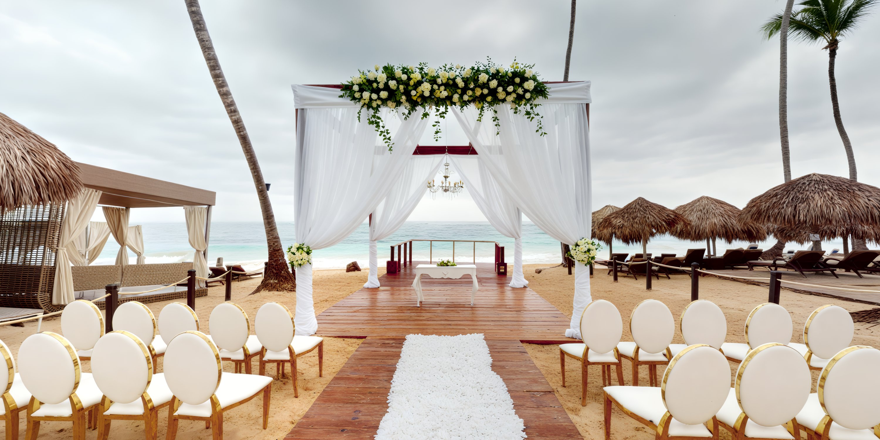 A picturesque destination wedding setup featuring a stunning beachfront location with elegantly arranged chairs, a beautiful floral arch, and a breathtaking ocean view.