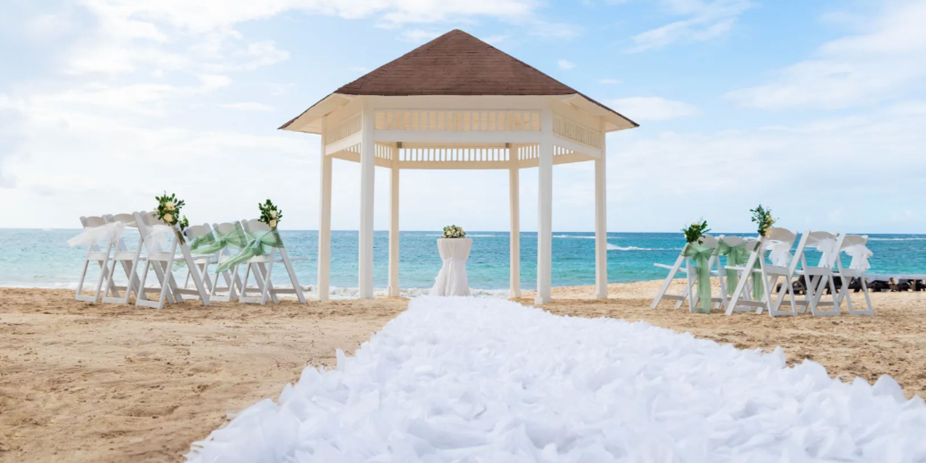 Royalton Punta Cana beach gazebo decorated with flowers and chairs for a romantic destination wedding.