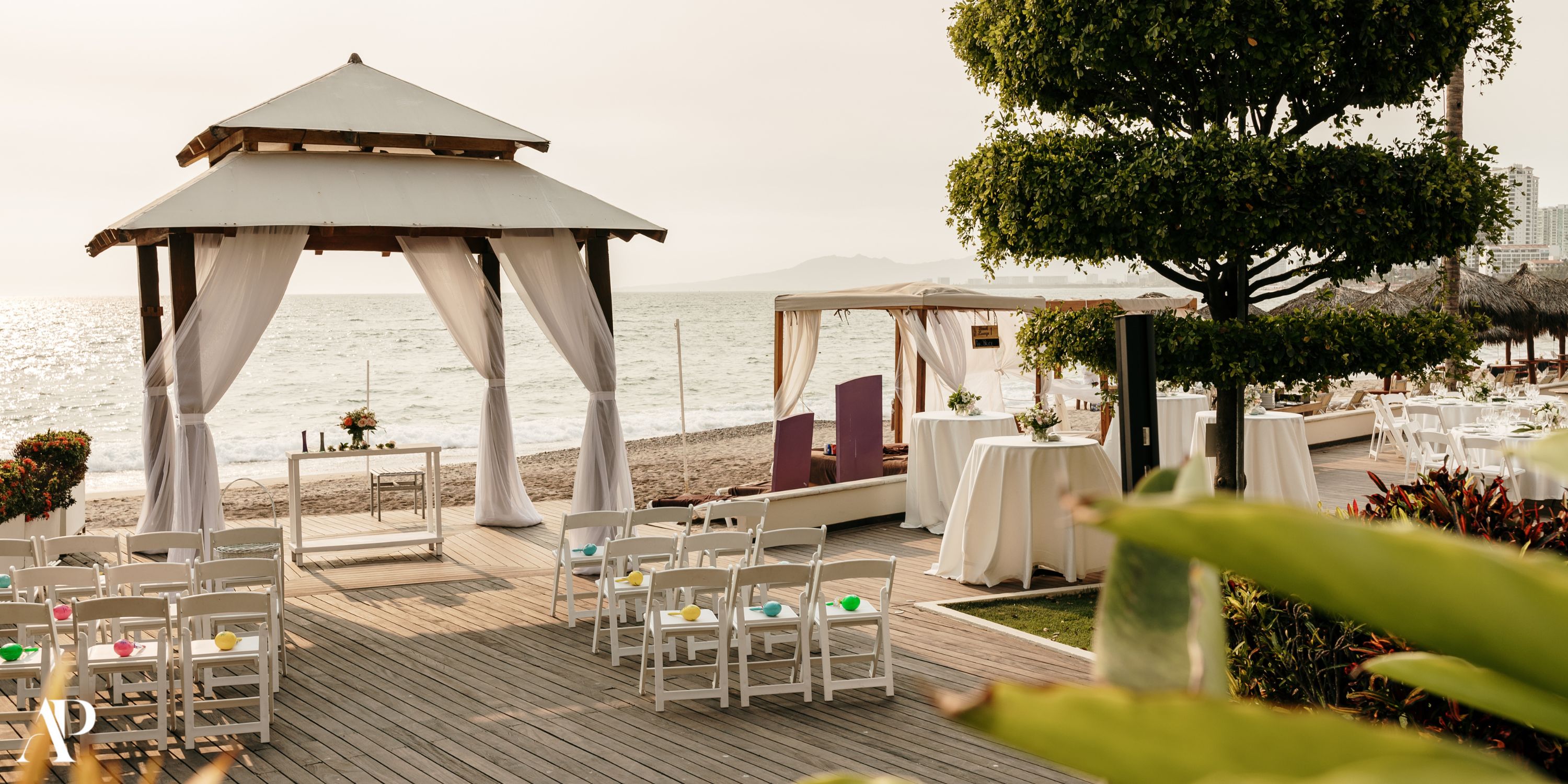 Destination wedding setup at Secrets Vallarta Bay with chairs, gazebo, and oceanfront decorations.