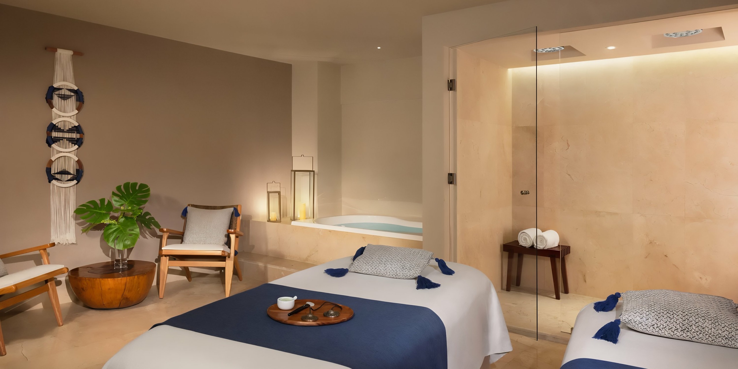 Modern spa room with two Dreams Aventuras Riviera Maya, a built-in bathtub, and tranquil decor.