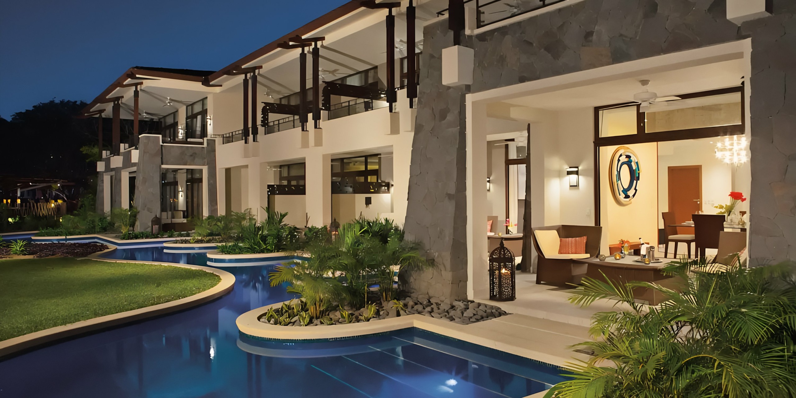 Luxurious modern home exterior with a swimming pool at twilight, reminiscent of Dreams Las Mareas.