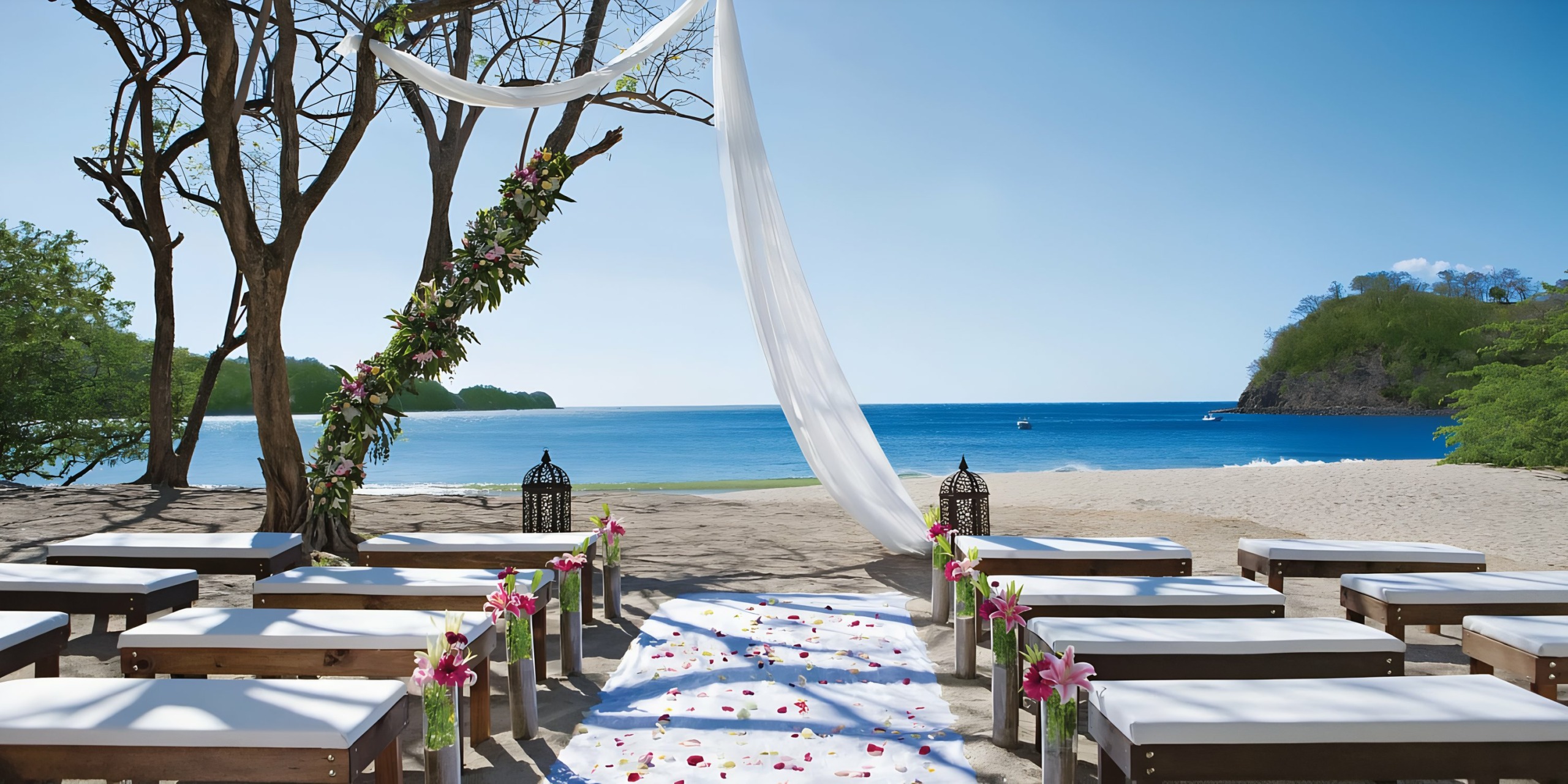 Dreams Las Mareas wedding setup with a white fabric arch and floral decorations, overlooking the ocean.