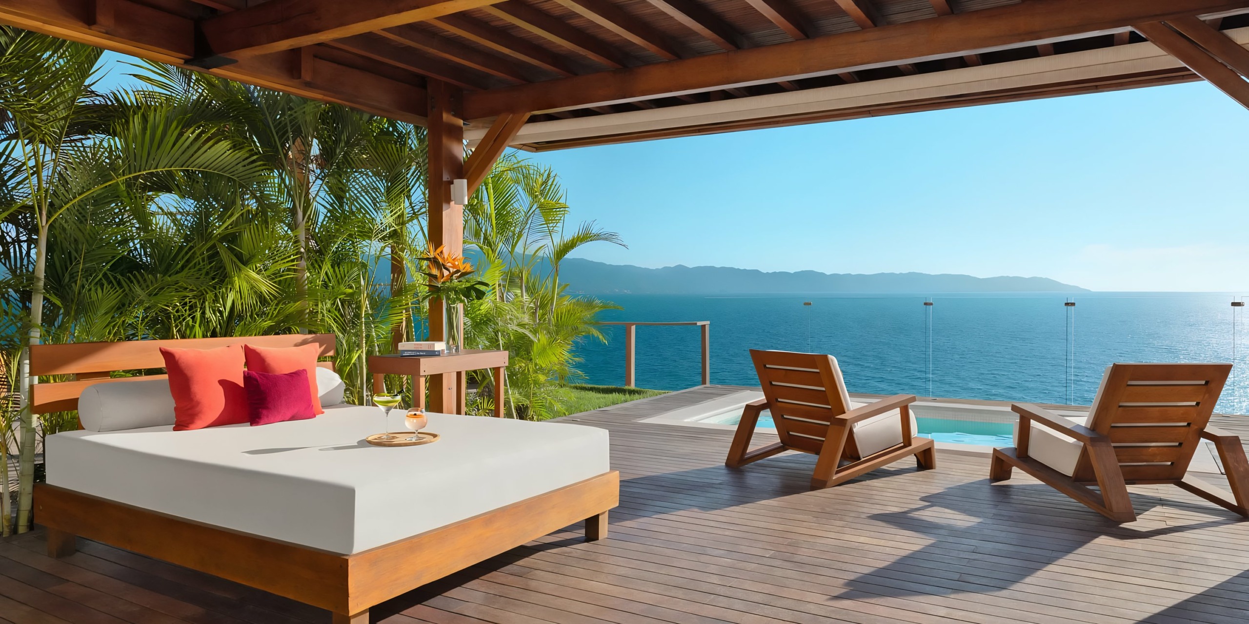 Dreams Vallarta Bay seaside patio with comfortable seating, infinity pool, and panoramic ocean view for an idyllic wedding setting.
