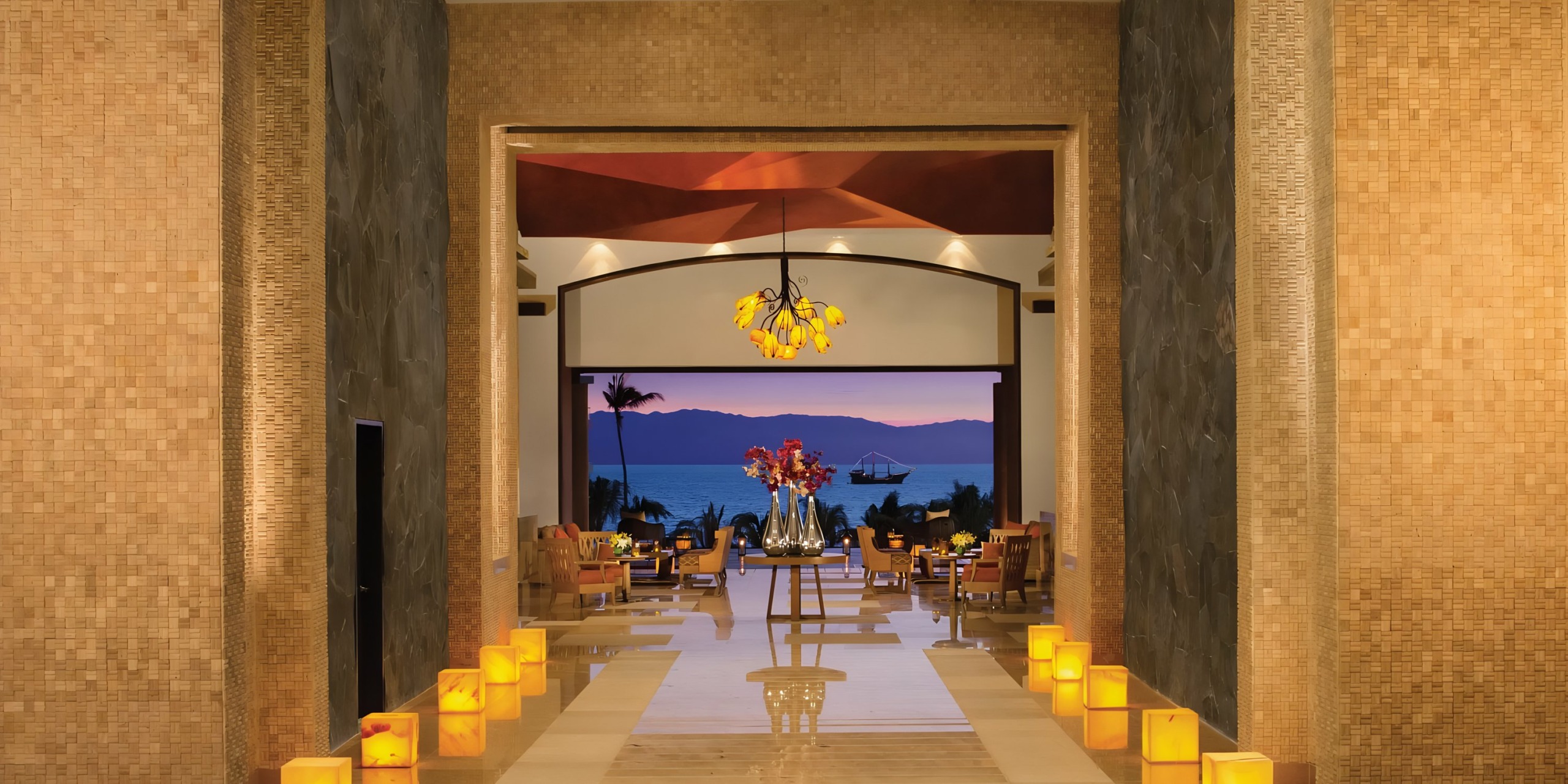 Dreams Vallarta Bay resort lobby with ocean view, ideal for a wedding, at twilight.