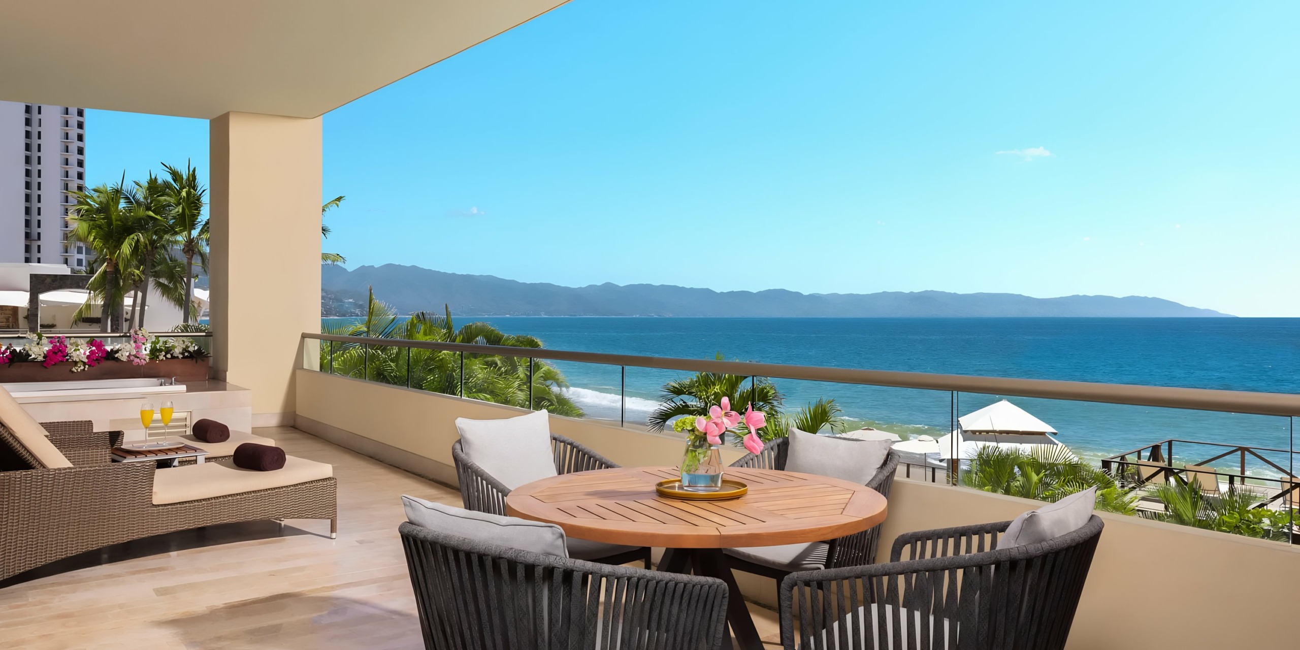 Dreams Vallarta Bay oceanfront balcony with seating area and scenic wedding view.