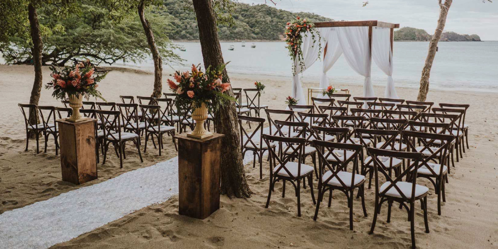 A Dreams Las Mareas wedding ceremony set up on the beach.