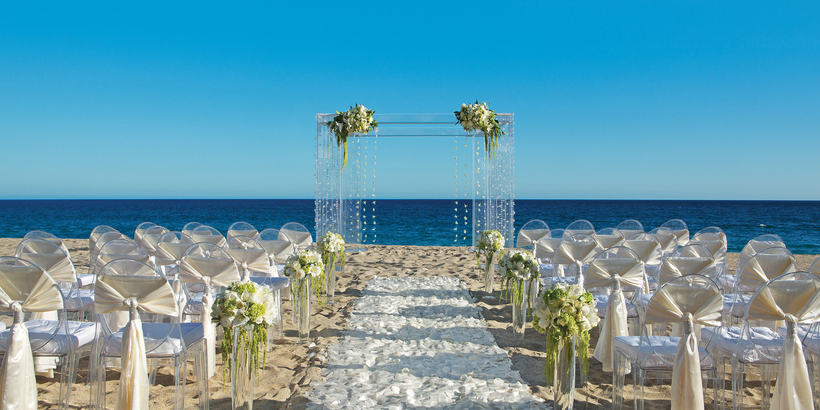 A Dreams Curacao wedding ceremony set up on the beach.