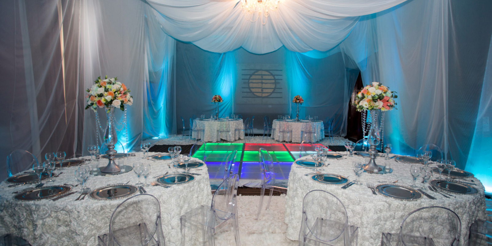 A wedding reception set up with Dreams Palm Beach tables and chairs.