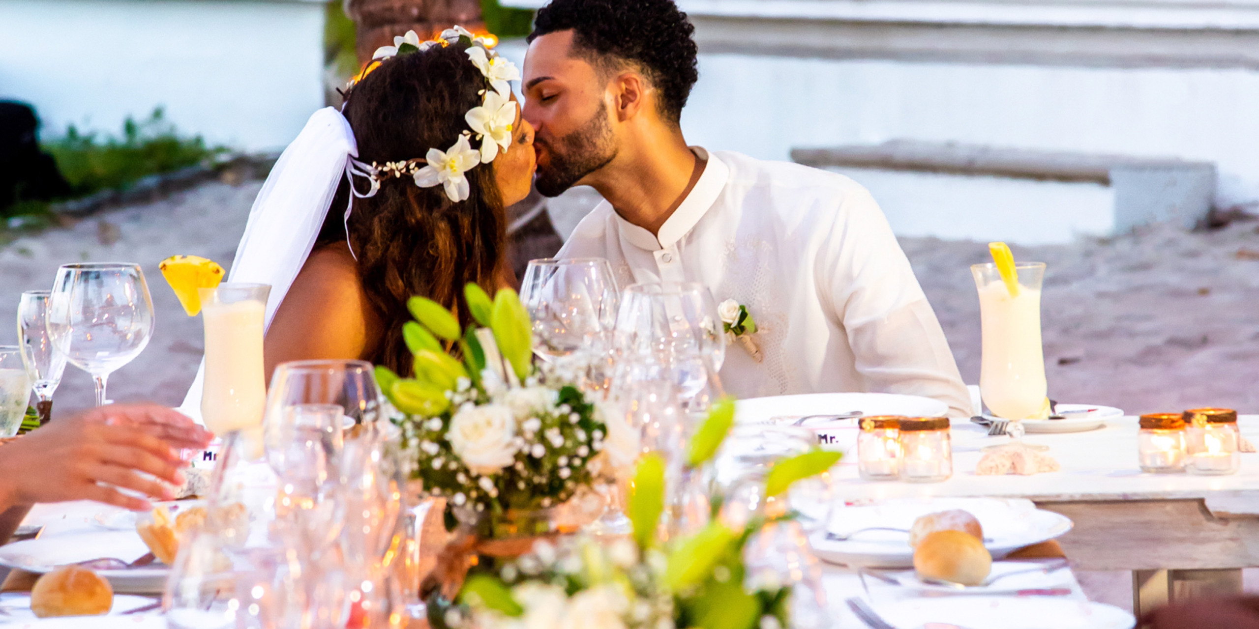 Gabby and Steven kiss at their destination wedding reception