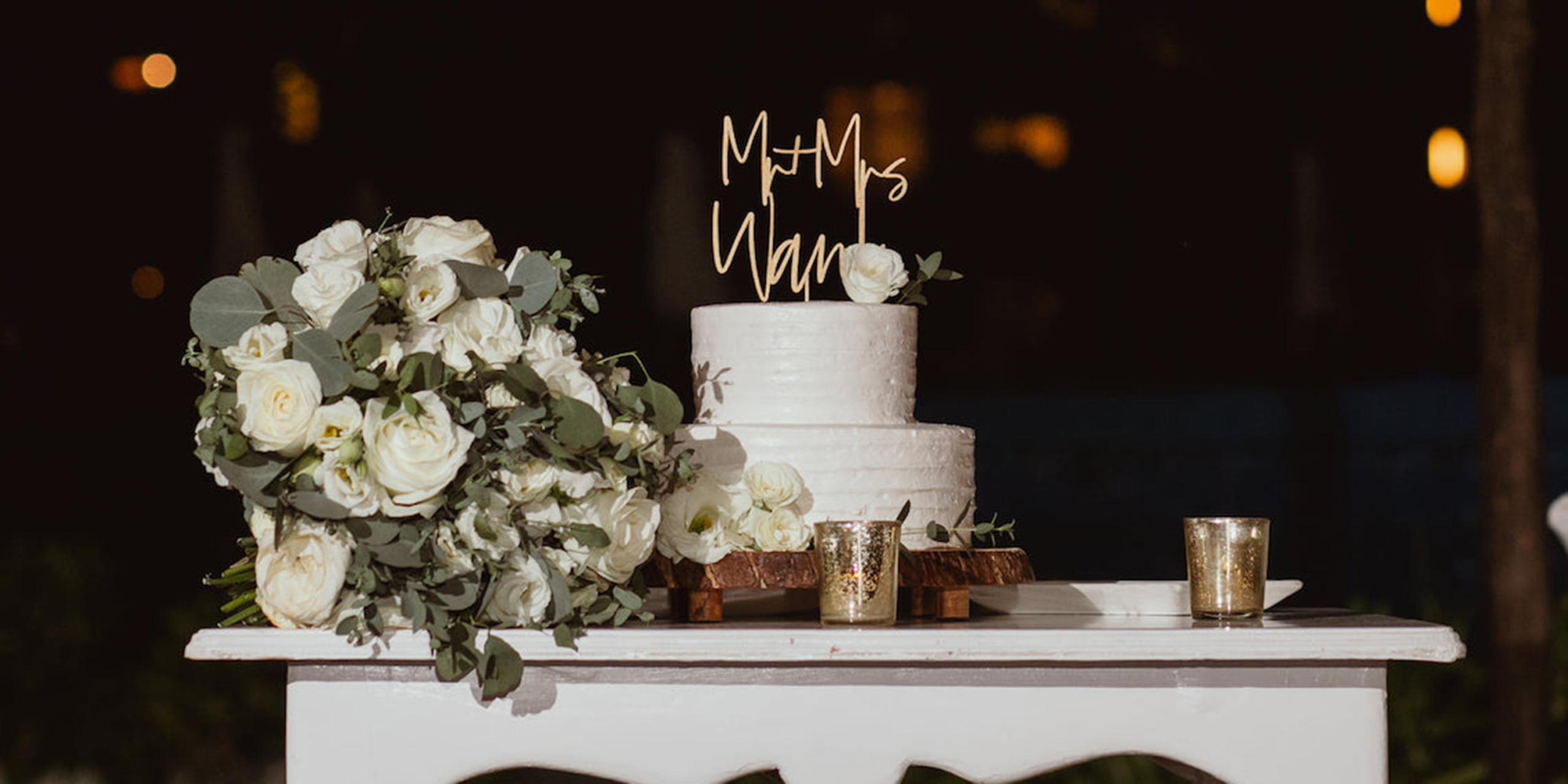Hannah and Ben with their cake and bouquet of their dream destination wedding from Destify