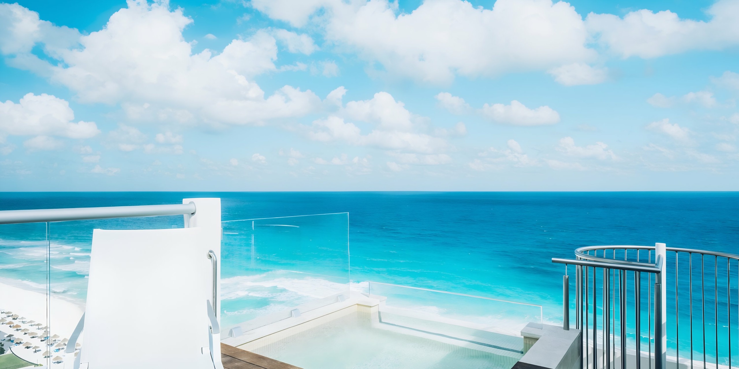 Iberostar Selection Cancun view from a modern balcony with a glass railing and an infinity pool.
