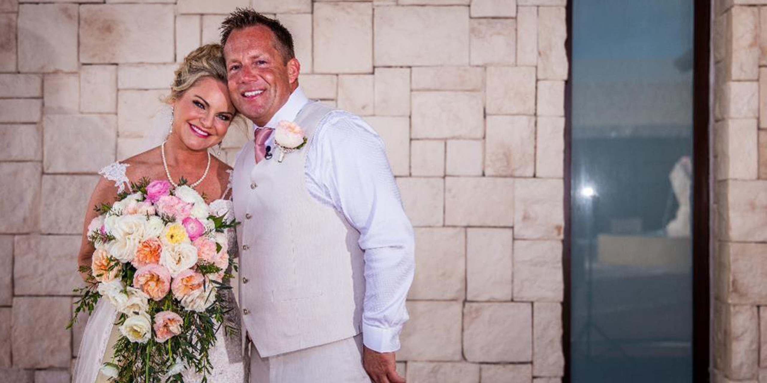 Jacqueline and Troy pose with their beautiful bouquet