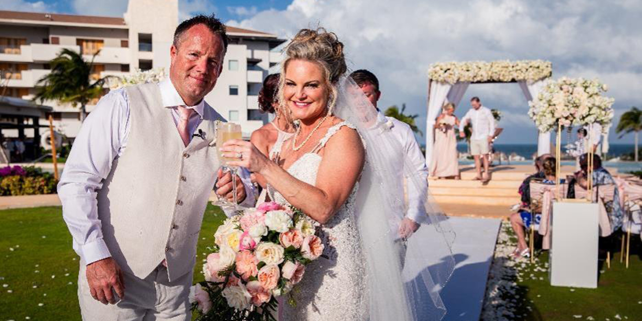 Jacqueline and Troy celebrate with champagne after their wedding while also getting married
