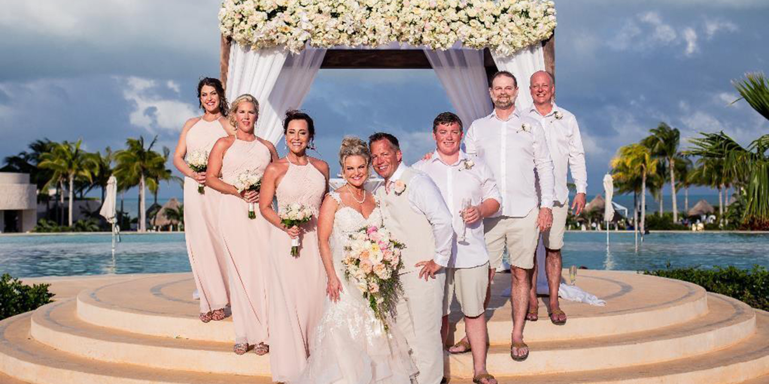 Jacqueline and Troy pose in a photo with all their funny friends and family bridesmaids and groomsmen and son