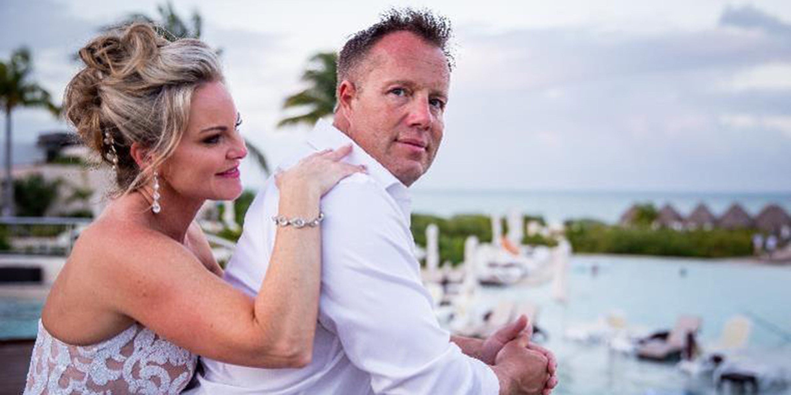 Jacqueline and Troy pose together for a destination wedding photograph