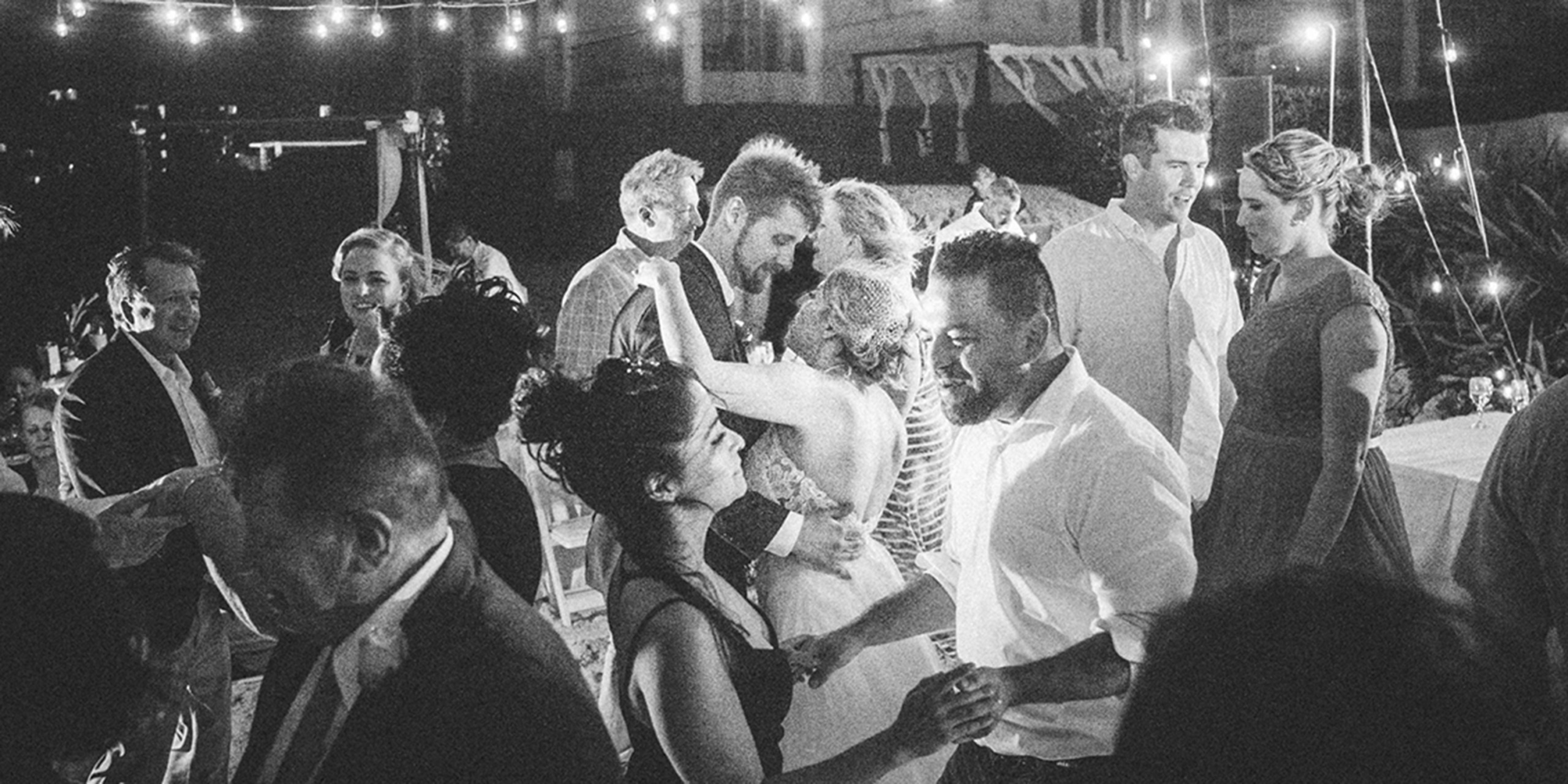 Jasmine and Brad dance with their guests at their wedding reception on the dancefloor