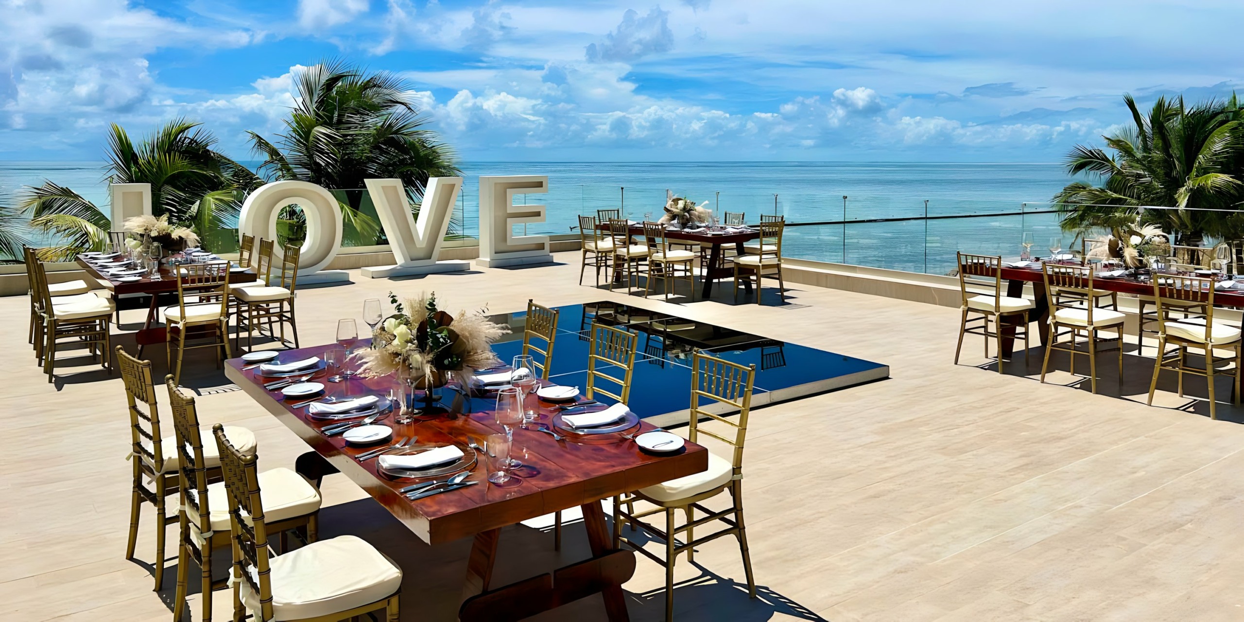 A wedding reception set up at Breathless Riviera Cancún Resort & Spa overlooking the ocean.