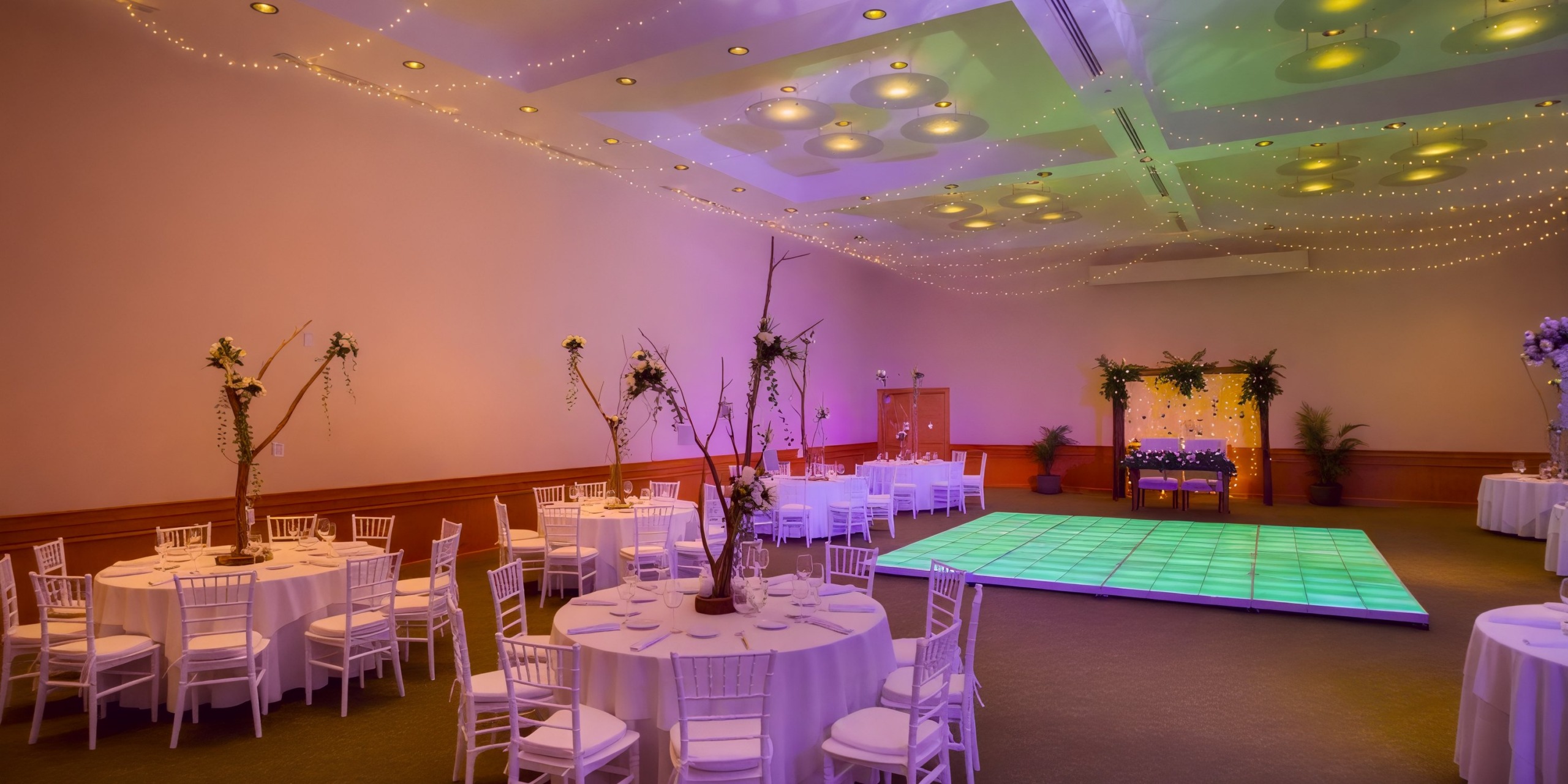 Marival Emotions offers an elegant reception hall, perfect for a destination wedding, featuring beautifully decorated tables and an illuminated dance floor.