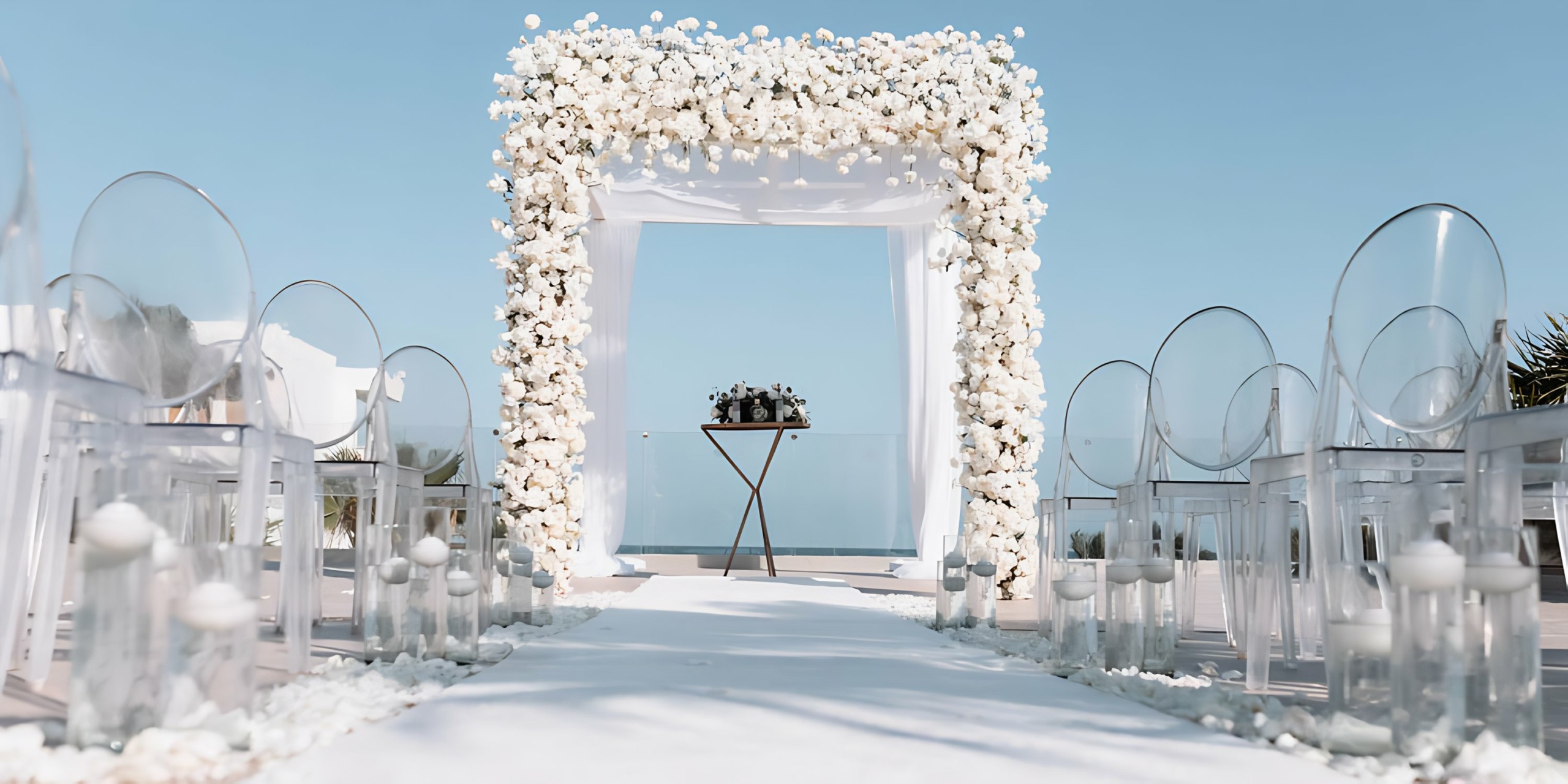 A wedding ceremony set up at Breathless Riviera Cancún Resort & Spa with white flowers and candles.